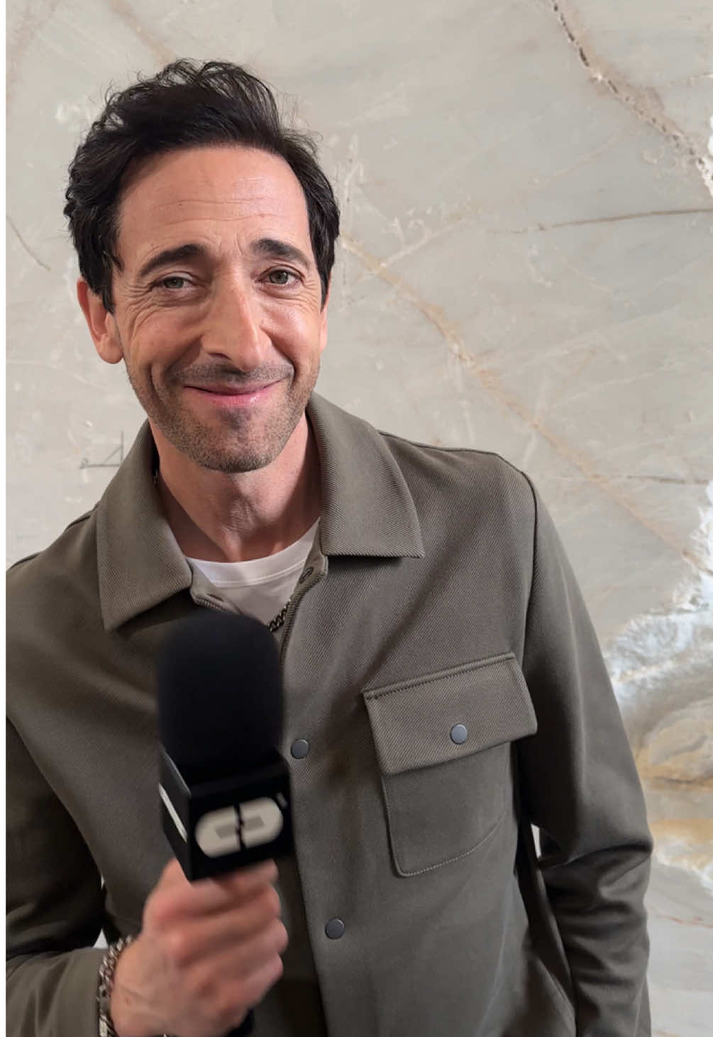 Come with us to hit up COS’ SS25 show, where the brand took over a marble cave in the Athens forest. Adrien Brody and Gemma Chan looked on from the FROW as COS stayed true to its signature codes (the brand is the GOAT of minimalism): the tailoring was clean, sculptural, and wearable - the kind of timeless wardrobe staples you’re reluctant to part with. In other words, COS stays winning. Here’s what went down.