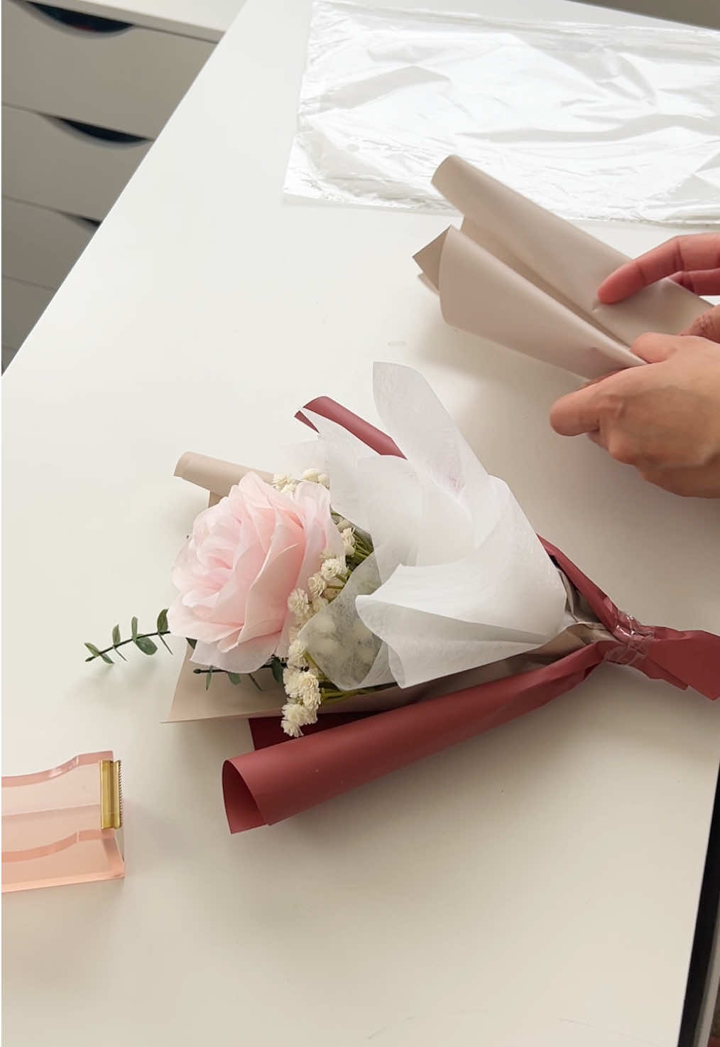 Sorry this took so long! But a wrapping tutorial was requested for our popular red bouquet— as you can see, I didn’t have the fresh flowers so I had to improvise 😅  Should I do more wrapping videos??👀  #flowertok #novaflorist #koreanflowerbouquet #flowerwrappingtutorial #koreanwrappingpaper #flowerwrappingpaper #minibouquet #fyp 