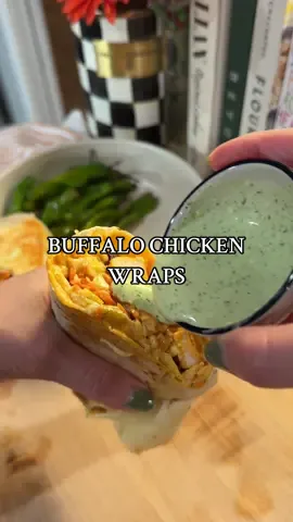 Buffalo chicken wraps with peperoncini ranch  For the wrap: Large tortilla Buffalo chicken bites Monterey jack cheese  Slaw Shredded carrots  Pickles Pepperoncinis Additional buffalo sauce Pepperoncini ranch  Chicken: 2 chicken breasts, cubed  ¼ cup flour ¼ cup  cornstarch 2 tbsp avocado oil ¼ tsp onion powder ¼ tsp garlic powder ¼ tsp paprika ½ tsp salt ½ tsp pepper ¼-½ cup buffalo sauce (per desired sauciness) Method: In a bowl, mix flour, cornstarch, and dry seasonings. Cube your chicken breast and add to a separate bowl. Coat with avocado oil before adding cornstarch, flour, and dry seasonings mixture. Mix well until chicken is coated. Add to a baking sheet lined with parchment paper and make sure chicken is spread out into an even layer. Bake at 425 for about 12 minutes or until cooked through. Once done, coat chicken with buffalo sauce. Slaw: 2-3 cups coleslaw mixture  3 tbsp mayo  2 tbsp apple cider vinegar 1 tbsp dijon 1 tbsp hot honey Salt, to taste Pepper, to taste Pepperoncini ranch: ¼ cup mayo ⅓ cup greek yogurt 1 tsp buttermilk Handful of dill Handful of chives 2 tbsp pepperoncinis 2 cloves garlic Juice ½ lemon Additional buttermilk (if needed) Method: Add all ingredients to a blender and blend until mixed. You can also use an immersion blender. I like to taste test and add in additional buttermilk as needed to get to desired consistency. #dinner #cooking #Recipe #easyrecipeideas #EasyRecipes #EasyRecipe #dinnerinspo #buffalochicken 