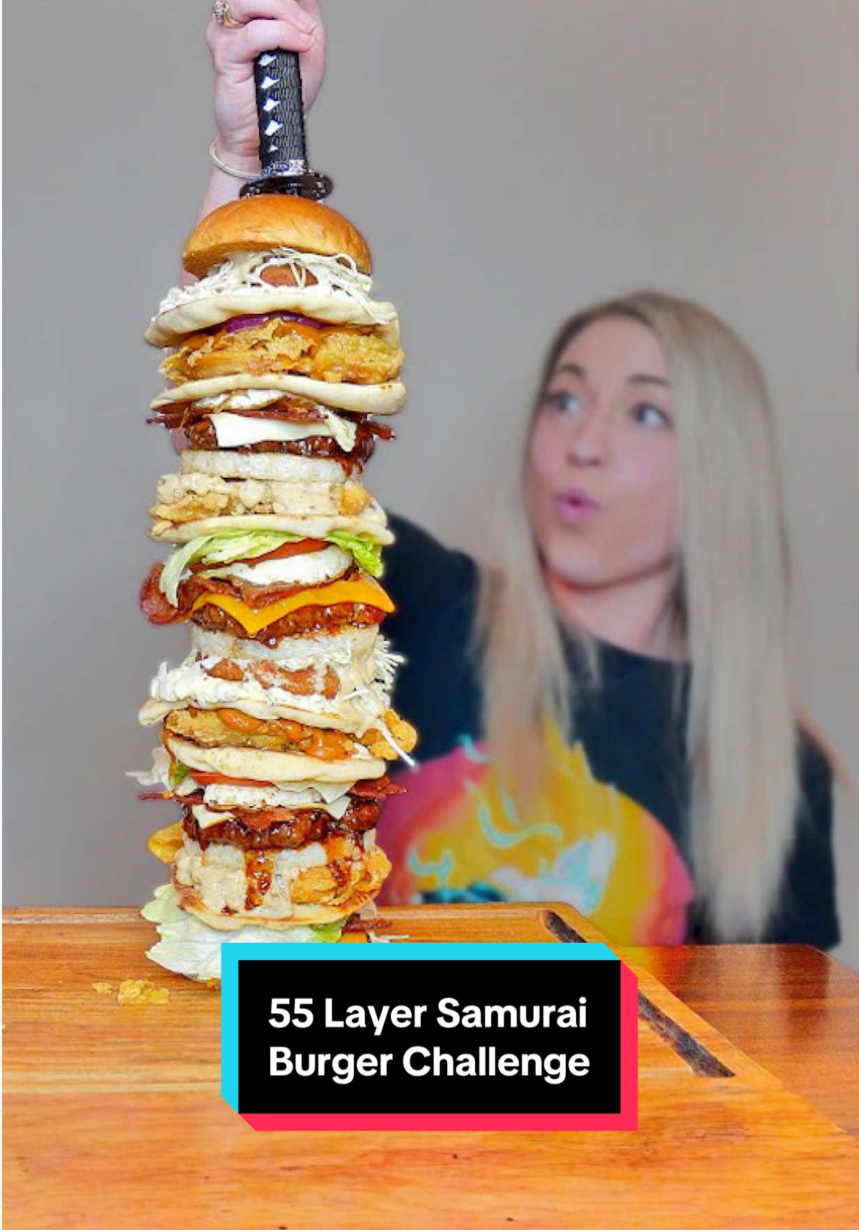 I have just 30 minutes to finish a burger featuring 55 layers of beef, fish, chicken, cheese, naan, rice patties, burgers buns, sauce and veggies, held together by a samurai sword! Let’s do this!! #foodchallenge #katinaeatskilos #fyp #tower #burger #giant #Foodie #challenge #foryou 