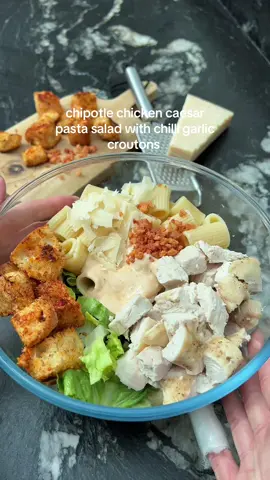 Boring salads? Never heard of her 👀 Spicing up my caesar game with this banging chipotle chicken caesar pasta salad with crunchy chilli garlic croutons 😮‍💨 it’s absolutely gorgeous  ‼️Need more tasty recipes? Grab my cookbook Low-Cal Kitchen Bangers—link’s in the bio!🫶🏼 Ingredients (Serves 2): 200g chicken breast Salt  Pepper  ¼ tsp garlic granules  100g dry pasta  1 head of romaine lettuce, chopped 15g parmesan cheese, shaved Tsp bacon bits Chili Garlic Croutons: ¾ of a ciabatta roll, cubed  A few sprays of olive oil  1 tsp paprika  1 tsp chopped garlic (can sub for garlic granules)  ½ tsp mild chilli flakes (adjust to your heat preference)  For the dressing: 45g lighter mayo 30g fat free greek yoghurt  ¼ tsp Dijon mustard 2 tsp lemon juice  ½ tsp chopped garlic  ½ tsp Worcestershire sauce *can sub for anchovy paste 5g parmesan, grated ¾ tsp chipotle paste Pinch of salt 1-2 tbsp water to loosen  💕 Preheat the oven to 180 degrees celsius.  Season the chicken with salt, pepper and garlic granules. Bake for 18 minutes. Once cooked, cut into cubes and leave to cool. 💕Add the pasta to boil in a large pan of salted water. Once cooked, rinse under cold water and set to one side  💕Spray the cubed ciabatta with the olive oil before adding in all the other ingredients listed. Toss to coat well, and add to a baking tray. Bake for 8 minutes or so, tossing part way through.   💕Mix together all of the sauce ingredients. 💕Add the lettuce to a large bowl, along with the pasta, chicken and  ½ of the croutons. 💕Add the dressing, before topping with the shaved parmesan and bacon bits. 💕Toss everything to combine well before adding the remaining croutons.  Calories per portion: 520 l Protein: 43.5g l Fat: 9.5g l Carbs: 61.9g  • • ________ #pastasalad #caesarsalad  #DinnerIdeas #healthyrecipes #lowcaloriemeals #highprotein #EasyRecipes 