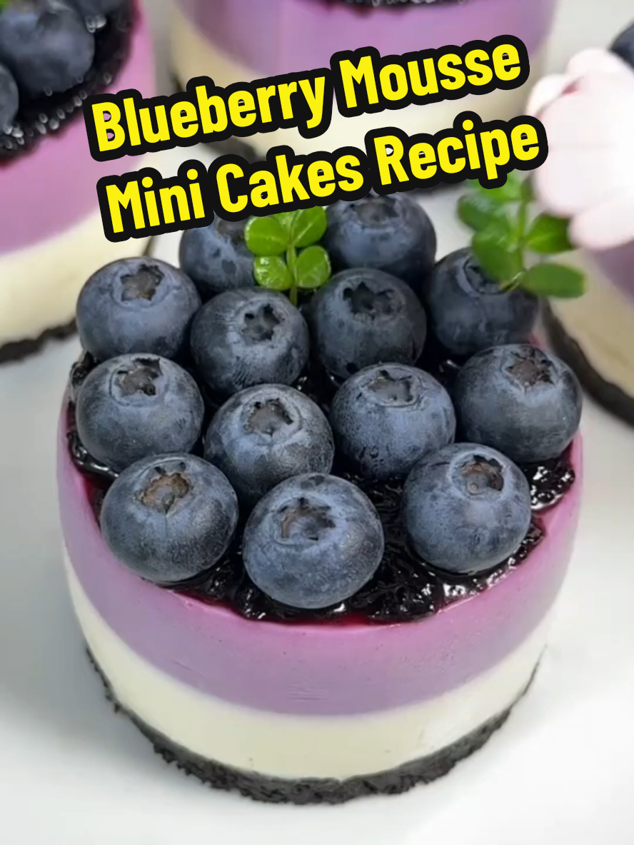 Blueberry Mousse Mini Cakes Recipe 👇 (No-Bake) 👉Ingredients: Cookie Crust 8 chocolate sandwich cookies (such as Oreos) 2.5 oz / 70 g 3 tablespoons unsalted butter, melted 42 g Blueberry Sauce 1 cup fresh or frozen blueberries 150 g 2 tablespoons granulated sugar 25 g Juice from ½ lemon 1 tablespoon / 15 ml Gelatin Mixture ½ cup whole milk, warmed to about 110°F 120 ml 1 sheet gelatin (softened in cold water) or 1 teaspoon powdered gelatin, bloomed in cold water 3 g Cream Cheese Mousse 9 oz cream cheese, softened 250 g 2 tablespoons granulated sugar 25 g 1 cup heavy cream 240 ml Optional Topping Remaining blueberry sauce Fresh blueberries Mint leaves Directions Step 1: Make the Crust Crush the sandwich cookies into fine crumbs using a rolling pin or food processor. Mix the crumbs with melted butter until evenly combined. Spoon the mixture into 4 small silicone molds or ramekins, pressing down firmly to form the base. Freeze the crusts while you prepare the mousse. Step 2: Prepare the Blueberry Sauce In a small pot, combine blueberries, sugar, and lemon juice. Simmer over medium-low heat, stirring constantly, until the mixture thickens slightly. Remove from heat and let cool. Step 3: Prepare the Gelatin Warm the milk to about 110°F (not boiling). Stir in the softened gelatin sheet or bloomed powdered gelatin until fully dissolved. Let cool slightly. Step 4: Make the Mousse In a bowl, mash the softened cream cheese with sugar until completely smooth. Add the heavy cream and stir or whip gently until the texture becomes smooth and silky. Stir in the warm gelatin mixture until fully incorporated. Divide the mousse mixture evenly into two bowls. Step 5: Assemble the Cakes Spoon or pipe the plain mousse (without blueberry sauce) into the molds, filling each one halfway. Freeze for 10 minutes until set. To the second portion of mousse, add 3 tablespoons (about 50 g) of the cooled blueberry sauce and stir until evenly combined. Spoon or pipe the blueberry mousse over the set plain layer. Refrigerate for at least 2 hours until fully set. Step 6: Unmold and Serve Once the mousse is firm, gently warm the outside of the molds using a hair dryer on low heat or your hands. Carefully remove each cake from the mold. Top with a spoonful of leftover blueberry sauce, and garnish with fresh blueberries and mint leaves if desired. Makes: 4 mini cakes #creatorsearchinsights #Recipe #EasyRecipes #cake #dessert #blueberry #cookingathometiktoktv #delicious 