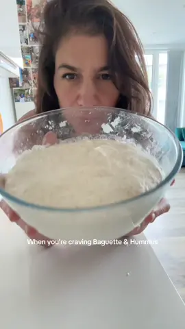 Creamy Hummus Recipe ⬇️ The recipe for the XL baguette is on my page, let me know if you want it and can’t find it 🩷 230g cooked drained chickpeas (jar, tin or carton) Bicarbonate soda 120g tahini @alnakhilco.sal ALWAYS 🫶 1 x garlic clove  1/4 tsp cumin  1 x tsp salt  1.5 - 2 lemons squeezed  1 or 2 tbs olive oil  100ml ice cold water  Start by draining & rinsing chickpeas in a sieve. Put them in warm water with a teaspoon of bicarbonate of soda and soak for 10 - 30 min then rinse. Put 100ml of cold water in the freezer to get really cold.  Peel the chickpeas, it will be super easy what the soak. I squeeze them gently between my fingers and let them fall into a clean bowl and throw the skin to the side.  Once they’re skinned add all the other ingredients except the water and blend either with a hand blender or a food processor. I prefer the hand blender. Once it’s smoothish add some of the ice water 1 x tbs at a time and blend in between. Add as much as you like to create the consistency you like. I like it super creamy. Keep airtight in the fridge. Enjoy 🫶 #fyp #hummusrecipe #hummus