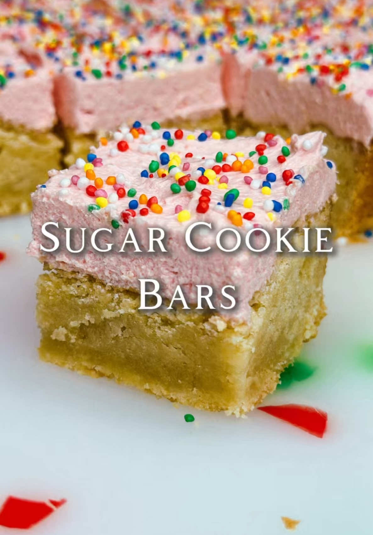 Sugar Cookie Bars Recipe: Sugar Cookie Bar: - 225g Unsalted Butter (Room Temp) - 300g Granulated Sugar - 1 Egg (Room Temp) - 1 Tsp Vanilla Extract - 320g Plain Flour - 1/4 Tsp Salt  - 1/4 Tsp Baking Soda  Buttercream Frosting:  - 113g Unsalted Butter (Room Temp) - 505g Powdered Sugar (Sifted) - 2 Tsp Vanilla Extract - 1-3 Tbsp Milk - Pink Food Colouring  - Sprinkles  - Preheat the oven to 180 degrees Celsius. Grease and line an 8-inch square pan with parchment paper and set aside. - In a large mixing bowl, cream the butter and sugar. - Add the egg and vanilla then beat again until combined. - Sift in the flour, salt and baking soda. - Using a spatula fold together until just combined.  - Transfer the dough to the lined pan and press down into an even layer. - Bake for 20-25 minutes or until golden. Allow to cool fully. - In a large mixing bowl, beat the butter until creamy, then add 1 cup of the powdered sugar and beat until combined. - Add the powdered sugar 1 cup at a time until fully combined. - Add the vanilla and 1 Tbsp of milk at a time until desired consistency. - Add the food colouring until the desired colour. - Carefully remove the cookie from the pan. Frost the cookie using a spatula and top with sprinkles. - Slice up and enjoy!  #sugarcookies #baking #buttercream #Love 