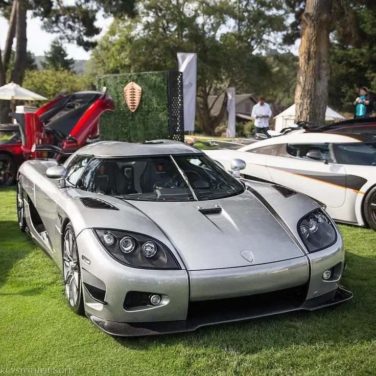 KOENIGSEGG CCX El Koenigsegg CCX, lanzado en 2006, es un súper deportivo sueco que representa el pináculo de la ingeniería automotriz y el rendimiento extremo. Este vehículo es una prueba de la capacidad de Koenigsegg para crear autos que no solo rompen récords, sino que también redefinen los límites de lo posible en el mundo del automovilismo. Bajo el capó, el CCX está equipado con un motor V8 de 4,7 litros hecho a medida con doble sobrealimentación que produce una potencia asombrosa de 806 caballos de fuerza. Este motor, diseñado y construido internamente por Koenigsegg, permite al CCX alcanzar una velocidad máxima de más de 395 kilómetros por hora. El Koenigsegg CCX fue diseñado para romper récords de velocidad. En 2006, fue uno de los autos más rápidos del mundo. El nombre CCX significa Competition Coupé X, la X representa el décimo aniversario de la fundación de Koenigsegg. Las puertas del CCX, que se abren hacia arriba y adelante, son una marca registrada de Koenigsegg. Este diseño no solo es visualmente impactante, sino que también facilita el acceso en espacios reducidos. El Koenigsegg CCX es más que un súper deportivo. Es una obra maestra de la ingeniería. Representa la visión de Christian von Koenigsegg de crear el coche definitivo. A pesar de que han pasado años desde su lanzamiento, el CCX sigue siendo un icono en el mundo de los súper deportivos, admirado por su capacidad para llevar la ingeniería sueca al límite y más allá.#koenigsegg #ccx #edits #carros #carros
