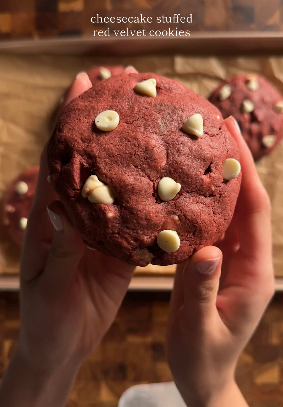 cheesecake stuffed red velvet cookies filling: 1/3 cup (100g) cream cheese, softened 1 1/2 tbsp (20g) white sugar 3/4 tsp (3.5g) vanilla extract 1/2 tbsp (7g) corn starch 1/2 tbsp (7g) heavy cream *combine in a bowl until well combined. scoop into 4 equal portions and freeze for about an hour at least.  dough: 1 1/3 cups (175g) ap flour 1 1/2 tbsp (10g) cocoa powder 1/2 tbsp (7g) corn starch 1 tsp (4g) baking powder 1/4 tsp (1.5g) salt 6 tbsp (90g) unsalted butter, cold and cubed 1/4 cup (45g)  white sugar 1/3 cup (80g) brown sugar 1 1/2 tsp (7g) vanilla extract 1 1/2 tsp (7g) red food dye (liquid) 1 large egg (about 55g) 2/3 cup (100g) white chocolate chips, plus extra for topping *cream together the butter and sugars well. then add in the egg, vanilla. once well mixed, add in the red food dye (or beet powder). in another bowl, whisk together the flour, cocoa powder, corn starch, salt, and baking powder. add the dry to the wet and gently fold until its just combined. portion into 4 equal portions (yes these will be big cookies) and chill in the fridge for at least an hour. once all chilled, create a dent in the dough and stuff with the frozen cream cheese filling. seal the dough together well. bake at 350 for about 16 minutes. recipe ib: thescanline #cheesecake #redvelvet #cookies #baketok #Recipe