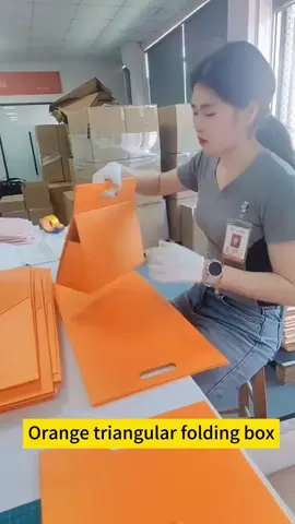 Innovative customized orange color triangular foldable gift box with handle, such a unique packaging box like a carry bag #foldingbox #foldablebox #giftbox #giftboxes #giftboxfactory #giftboxcustom #custombox #creativebox #creativepackaging 