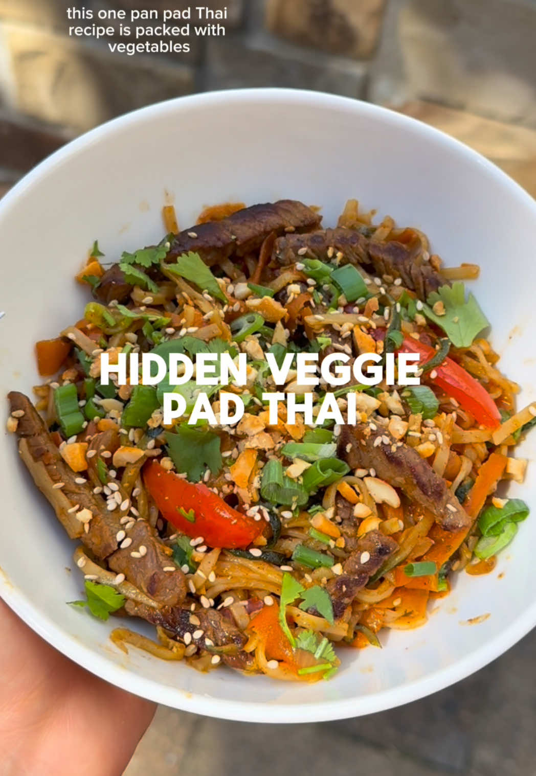 like always full recipe and instructions are below!👇🏼  One-Pan Pad Thai (with hidden veggies) 🫑🥕🥒🍜  Ingredients: makes 4 servings - ½ box Pad Thai rice noodles (i used Annie Chun’s) - 1 tbsp oil -  ½ yellow onion, chopped - 2 cloves garlic, minced - 1 tbsp minced ginger - 2 carrots, peeled into ribbons - 1 red bell pepper, thinly sliced - 1 12 oz bag frozen zucchini noodles, microwaved and drained - 1 lb lean beef, thinly sliced - 1 packet (7 oz) Pad Thai sauce (e.g., Passage to Asia) - Soy sauce, salt, and pepper to taste - Garnish: chopped green onion, chopped cilantro, crushed peanuts Instructions: 1. Cook the rice noodles until just al dente according to package instructions, then drain and set aside. 2. In a large skillet or wok, heat oil over medium heat. Add onion, garlic, and ginger, and sauté until fragrant. 3. Add carrots and bell pepper to the pan and cook until just tender. 4. Microwave the zucchini noodles according to package instructions, then drain well and add them to the pan with the other vegetables. Sauté briefly to remove excess moisture, then remove all the vegetables from the pan and set aside. 5. In the same pan, cook the sliced beef until browned and fully cooked. 6. Add the al dente noodles to the pan with the beef, then return the cooked vegetables. 7. Pour in the Pad Thai sauce and toss everything together until well mixed and heated through. Adjust the seasoning with soy sauce, salt, and pepper to taste. 8. Garnish with green onion, cilantro, and crushed peanuts before serving. macros: 409 kcal, 28 g/protein, 44 g/carbs, 12 g/fat, 3 g/fiber  #mealprep #dietitian #padthai #healthypadthai #healthyrecipe #recipeideas #recipeinspo 