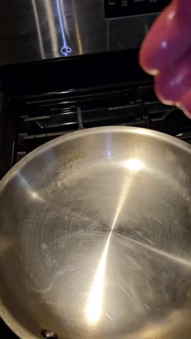 frozen burgers on a stainlesssteel pan