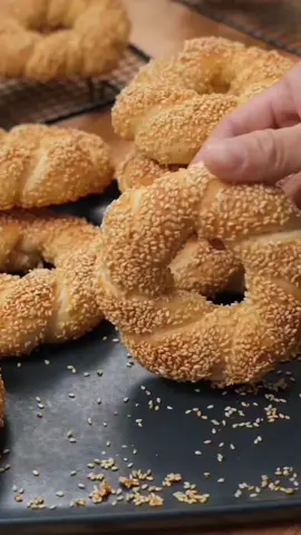 Sesame bagels 🥰 dough preparation bread flour 250g sugar 10g instant yeast 5g salt 2g water 130ml knead the dough for 3min olive oil 20ml knead the dough low speed for 10min rest the dough for 60min separate the dough into 6 pieces  make balls cover the dough rest the dough for 15min roll the dough cover the dough rest the dough for 15min make the sesame bagels take a bowl brown sugar 30g lukwarm water 100ml mix well sesame seeds 70g rest the dough for 30min Bake in a preheated oven 200C 12 to 15min depends on the oven #Recipe #bread #fyp #balkan #greece 