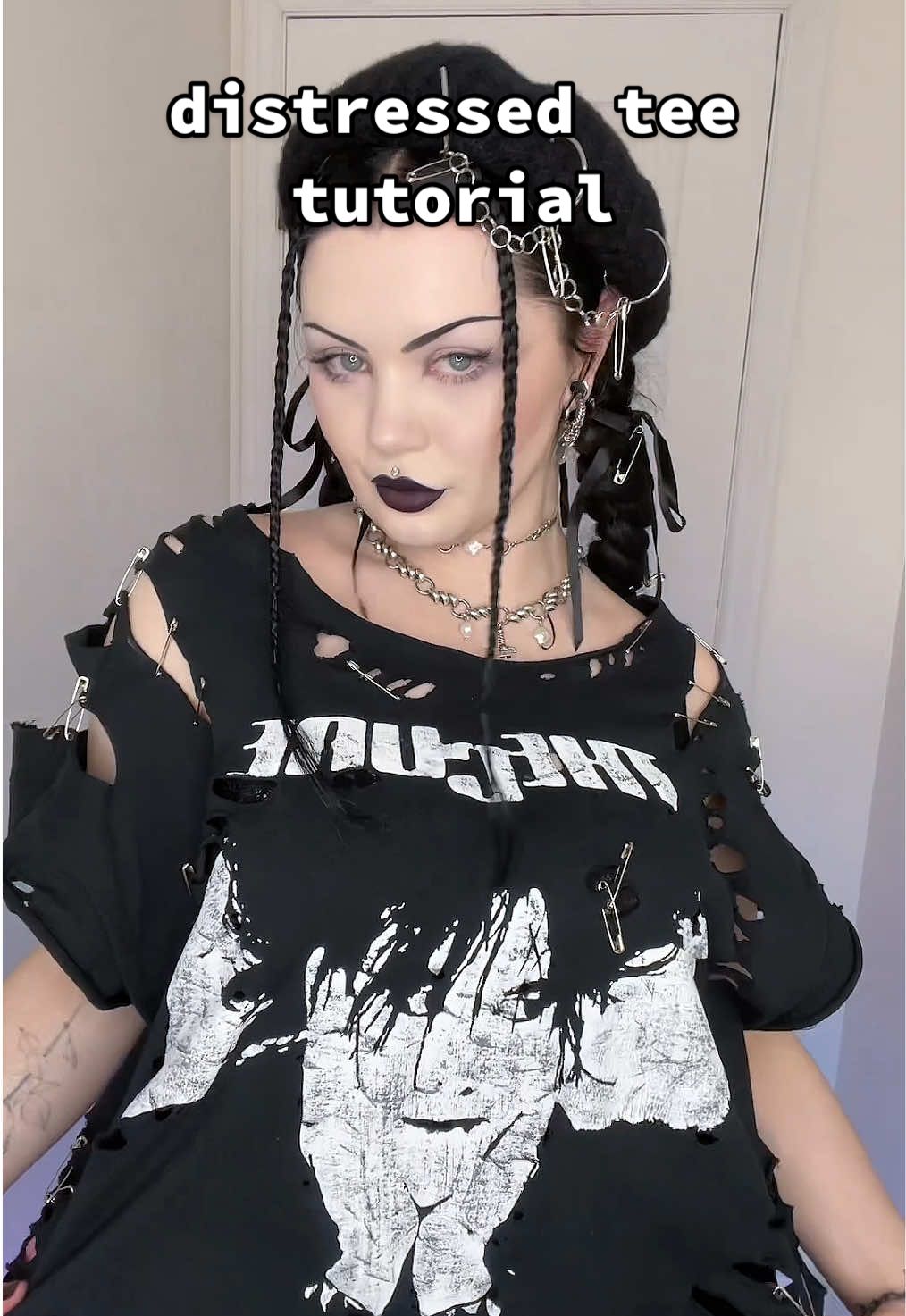 easy diy to try out✂️ • when I distressed my Bauhaus tee, I got a lot of requests for a tutorial  Tbh it’s nothing new, I think many know the techniques I used but, thought I’d share anyways☺️ Hope this helps!🖤 ____ ✖️Details: - band tee or any clothing item you’d like (I got mine at a local shop)  - sandpaper - scissors - safety pins  - mask when sanding  ___ ⛓️‍💥Jewellery: @Regalrose   • FORTUNE. Dagger & Pearl Charm necklace and bracelet* • LUSTRE. Pearl Choker* (*affilate* code VOCALLYSHOOK15 / shop 🔗 in my bio⬆️) ___ hair & makeup tutorial coming soon 🖤 _____ #DIY #distressing #alttiktok #gothtok #gothfashion  #easydiy #gothaesthetic  #punkfashion  #outfitinspo #outfitidea #Summer #casualgoth #fyp #foryou #foryoupage 