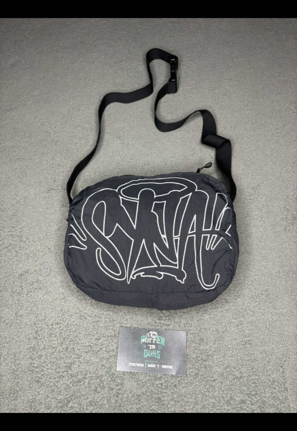 Syna world jacket in my bag. Shop the Syna windraker that can easily be turned into a shoulder bag with us . DM us to purchase 🛍️. #streetwear #synaworld #centralcee #zambiantiktok🇿🇲 #zambiantiktok🇿🇲🇿🇲 #ukstreetwear 
