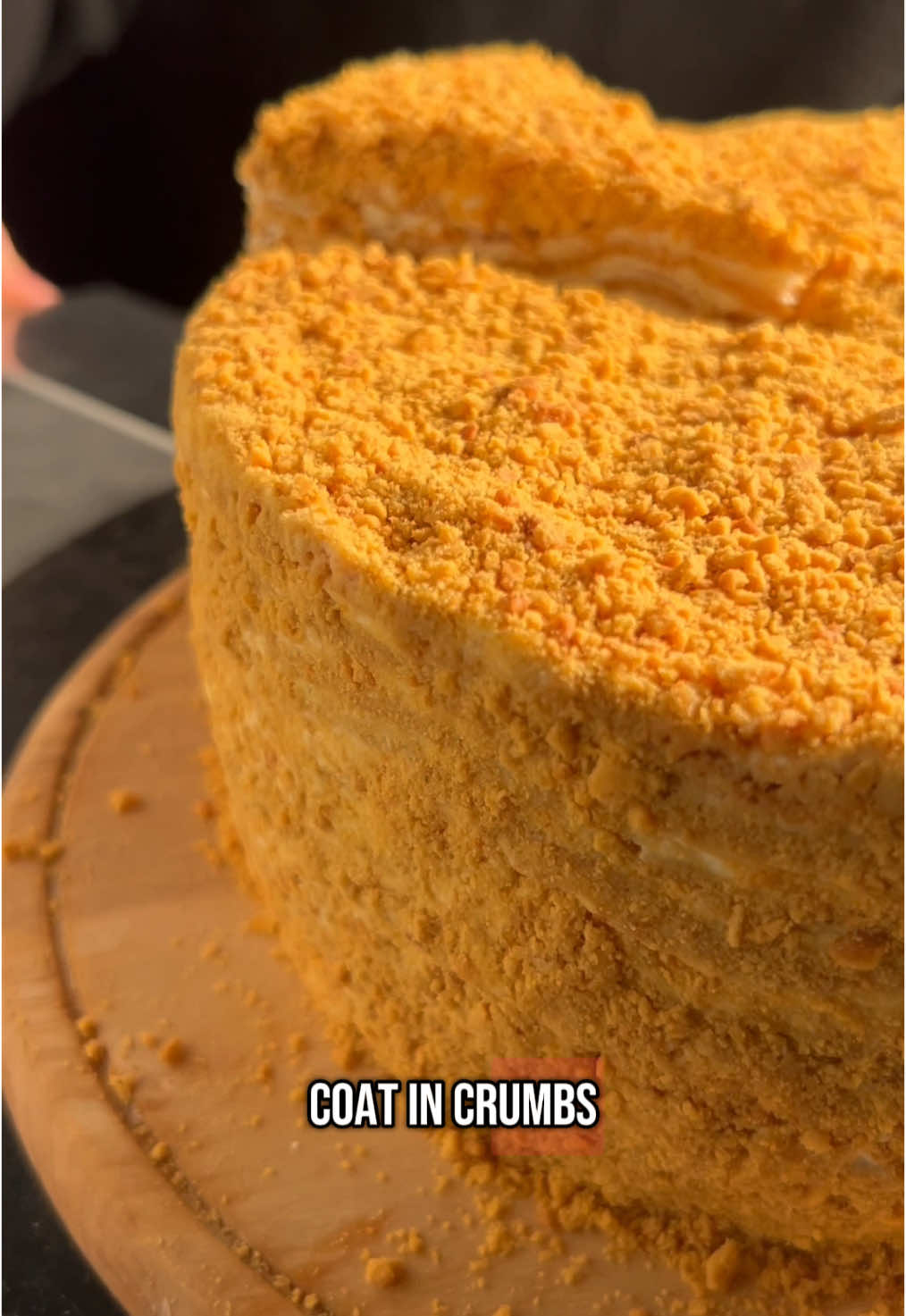 A cake that has special place in many hearts 🍯 Honey Cake Ingredients: Dough: 60g butter 60g sugar A pinch of salt 110g  honey 3/4tsp baking soda 1 egg and 1 egg yolk ~320g flour (add gradually,  Cream: 200g heavy cream 60g powdered sugar 400g sour cream Instructions: For the Dough: 1. Melt the Ingredients: In a medium saucepan over low heat, melt the butter, sugar, honey, and a pinch of salt. Stir occasionally until the mixture is smooth and well combined. Be sure to melt everything slowly and carefully to avoid burning. 2. Add Baking Soda: Once melted, stir in the baking soda. The mixture will foam up slightly. Keep stirring for about 1 minute until it gets darker color, then remove from heat. 3. Add the Egg: Let the mixture cool slightly before adding the egg. Whisk the egg in quickly to prevent it from curdling in the warm mixture. 4. Incorporate Flour: Gradually add the flour, mixing with a spatula or spoon until the dough comes together. The dough should be soft and smooth, not too sticky. 5. Refrigerate the Dough: Cover the dough with plastic wrap and refrigerate for 1 hour. This will help make it easier to handle and roll out. 6. Roll Out the Dough: Preheat your oven to 180°C. After the dough has chilled, divide it into 11 equal pieces. Roll each piece into a thin circle, slightly larger than 14cm in diameter. 7. Bake the Layers: Place each rolled-out piece on a parchment-lined baking sheet and bake for 5-7 minutes until golden brown. Repeat for all layers. 8. Cut Out the Layers: Once baked, immediately use a 14cm cake ring or template to cut out perfect circles from the warm dough. Set aside the trimmings for later use as decoration. 9. Whip the Heavy Cream: In a bowl, whip the heavy cream and powdered sugar until soft peaks form. 10. Add Sour Cream: Fold in the sour cream gently until the mixture is smooth and creamy. 11. Layer the Cake: Start with one honey cake layer on a serving plate. Spread a thin layer of cream on top. Repeat the process until all 14 layers are stacked, ensuring you have enough cream for the top and sides. 12. Coat the Cake: Use the remaining cream to coat the top and sides of the cake. 13. Chill the Cake: Refrigerate for at least 4 hours or overnight to allow the layers to soften and the flavors to meld. 14. Decorate with Leftovers: Crumble the leftover cake trimmings and sprinkle them over the top and sides of the cake. You can add fresh berries for a pop of color. #reels #recommendations #delicious #Foodie #cake #homemade #tiktok 