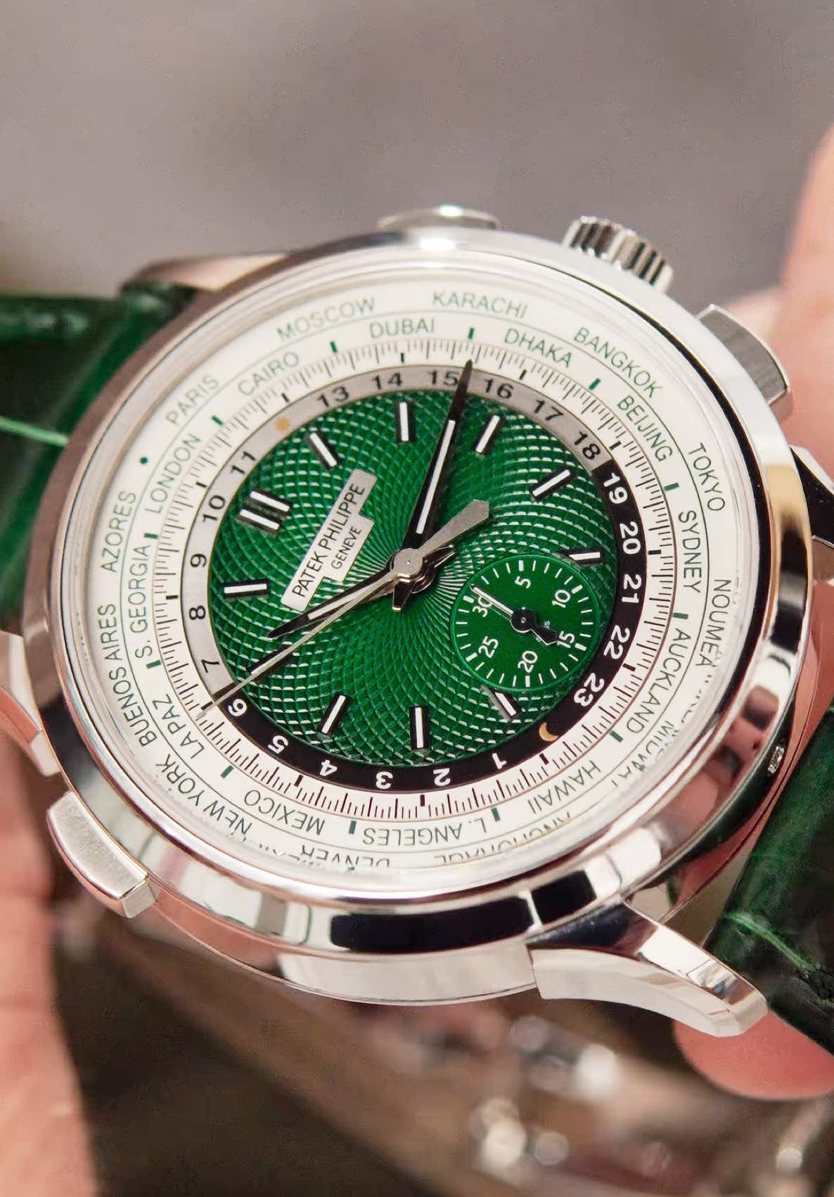 The undeniably gorgeous Patek Philippe World Time Chronograph reference 5930P-001, available now. Combing a World Time with a Chronograph is no easy feat, and this watch in question is undeniably complex whilst looking seamlessly elegant aesthetically. Housing the self-winding Calibre CH 28‑520 HU within, it gives the wearer permanent track of the time in all 24 time zones, which can be adjusted to the local time instantly through its patented mechanism by simply pressing the pusher at 10 o’clock. Two of the most useful complications combined make for the ultimate travel watch or daily companion. The watch’s real talking point is its hand-guilloched green dial with white gold, luminescent-filled applied hour markers and matching handset. Very much the colour of the past few years, green dial watches, and in particular, Patek Philippe references, have been tremendously popular amongst collectors worldwide, and when paired with the watch’s platinum case and matching-coloured alligator leather strap, it makes for quite the spectacle. Having been worn just a handful of times and totally complete with its entirety of accessories from new, the watch is available for viewing in London and purchase worldwide. Please get in touch for further information and pricing. #PatekPhilippe #WorldTime #PatekPhilippeWorldTime #Patek #5930 #5930P #watches #luxury #watchesoftiktok #fyp #watchtok #mensfashion #foryou #menswatches #style #watchoftheday 