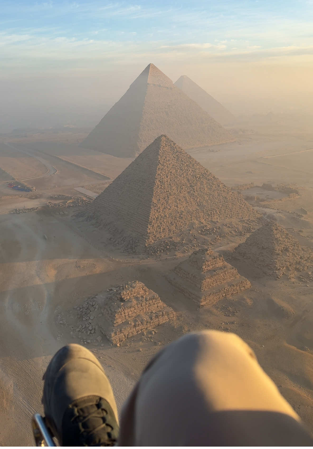 Paramotoring over the Great Pyramids in Giza! The company that runs this is called SkyOne and it cost me $250 to fly over the pyramids during sunrise! So worth it. I travel a lot and this is still in the top coolest things I’ve ever done on a trip #egypt #travel #traveltiktok #adventure #fyp #viral #trending #sunset #desert #vacation #wanderlust #amazing 