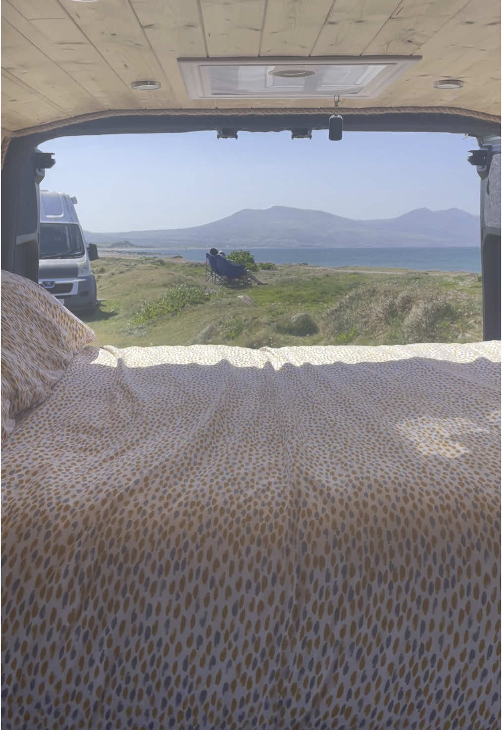 The view from my bedroom changes wherever I go ❤️ #vanlife #vanlifeuk #offgrid #Wales #dinasdinlle #fyp 
