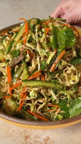 no grill? no problem. these noodles bring the cool 😎 this chilled soy & scallion noodle salad with sliced steak is perfect for prepping ahead and showing up to the party with something different. refreshing, savory, and layered with umami—this is the move if you want to stand out at the potluck. ingredients for 3 — * 1 pound flank steak * ⅓ cup momofuku soy sauce * 7 tablespoons fresh lime juice, divided (usually 1–2 fresh limes) * 3 tablespoons momofuku chili crunch hot honey, divided * 2 cloves garlic, grated * 3 packs momofuku soy & scallion noodles * 1 cup savoy or napa cabbage * 1 cup leafy greens, such as arugula, spinach, or watercress * 1 carrot, sliced or julienned * 1 cucumber, sliced or julienned * 1 bunch scallions, chopped * ½ cup mint, chopped * ½ cup cilantro (or basil), chopped * 3 tablespoons olive oil * kosher salt * crushed peanuts (optional) 1. start by marinating the steak. combine ⅓ cup of soy sauce, 3 tablespoons of fresh lime juice, 1 tablespoon of chili crunch hot honey, and 1 clove of grated garlic in a shallow dish. add steak and marinate in the refrigerator for an hour, or up to 6 hours. 2. brush grill pan or cast iron skillet with canola oil, then heat on high heat until hot. sear steak on both sides for about 3–4 minutes each side, depending on the thickness and your desired doneness. remove from the pan and let it rest on a cutting board. 3. while your steak is resting, boil noodles for 2 minutes, then drain and rinse with cold water. shake dry. 4. combine cooked noodles, cabbage, leafy greens, carrots, cucumbers, scallions, mint, and cilantro in a large bowl. in a separate bowl, whisk together the noodle sauce packets, dried scallion packets, remaining 4 tablespoons of lime juice, 1 clove of grated garlic, remaining 2 tablespoons of chili crunch hot honey, and 3 tablespoons of olive oil. 5. slice steak and add steak along with any juices to the noodle salad mixture. pour in dressing and toss to combine. taste for adjust with kosher salt, as needed. top with crushed peanuts, if desired, and serve.