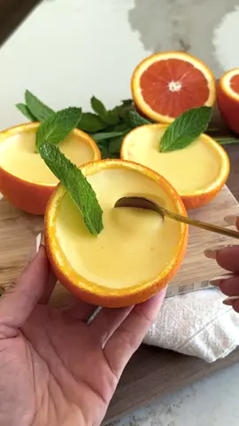 ORANGE POSSET// aka the easiest dessert you'll ever make 🍊✨ you only need 10 minutes of prep time, and just three ingredients: cream, sugar, and citrus.  I made this last summer and haven’t stopped thinking about it since. It’s rich, silky, light and full of flavor. + it's also SO EASY to eat too. like you won't want to stop.  comment RECIPE and i'll send ya the deets, or snag it down below!  Serve it in little jars, in an orange peel, try different citrus like grapefruit, lemon, blood orange etc! the possibilities are endless.  SAVE this one for when you want to impress without turning on the oven because we all know it's going to be too hot for that this summer!  1 cup heavy cream 1/3 cup cane sugar 1/4 cup orange juice 1-2 tsp vanilla  Zest from 1 orange 3 Orange Peel halves, or 4oz ramekins In a bowl, mix together the sugar and orange zest. Use your hands to rub them together until the sugar is fragrant and tinted orange. Whisk in the heavy cream and vanilla until smooth. Pour the mixture into a saucepan over low heat and bring to a gentle simmer. Remove from heat and immediately stir in the orange juice. Strain the mixture through a fine mesh sieve into a bowl to remove the zest. Cut two oranges in half, scoop out the insides, and pour the cream mixture into each hollowed-out orange half (or use ramekins if preferred). Refrigerate for at least 4 hours or overnight until set. Garnish with a mint sprig before serving, if desired. #orangeposset #posset #easydessertrecipe #nobakedesserts 