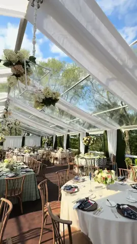 A tented ceremony at Milwaukee Country Club, designed by masters of the craft— ✨ A 15-piece orchestra framed by a custom monogrammed backdrop ✨ Tent trimmings and ceiling swags that danced above ✨ Floral chandeliers suspended in bloom, with layered florals gracing every table Elegance, orchestrated. ✨ PLANNING, DESIGN & PRODUCTION: @EVENTSTOAT @Emily Riordan DESIGN VIDEOGRAPHER: @FILMSBYDESIGN OUR PLANNING PARTNERS: VENUE: MILWAUKEE COUNTRY CLUB PHOTOGRAPHER: @JAKEANDERSONPHOTO CATERING & BAR: MILWAUKEE COUNTRY CLUB CAKE: MILWAUKEE COUNTRY CLUB FLORIST: @MILWAUKEEFLOWERCO TENT: @CANOPIESEVENTS DRAPING: @QUEST_EVENTS PAPER PRODUCTS: @BAYVIEWPRINTINGCO BAND: RON BEDAL ORCHESTRA CEREMONY MUSIC: @ELEGANT_MUSIC_SERVICES MAKEUP & HAIR: @GLAMANDGRACE HOTELS/ROOM BLOCKS: @WESTINMILWAUKEE @THETRADEHOTEL TRANSPORTATION: @LAMERSBUSLINES RENTALS: @THEFESTIVEFROG @NUAGEDESIGNSINC @REVERIE_SOCIAL @BBJLATAVOLA  Bride: @poochie  #MilwaukeeWeddings #TentedCeremony #LuxuryEvents #FloralDesign #OrchestraWedding #EventDesign #MastersOfTheCraft