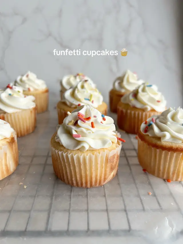 Ingredients For the Cupcakes: 	•	1¼ cup (200g) granulated sugar 	•	½ cup (113g) unsalted butter, softened 	•	2 large eggs, room temperature 	•	2 teaspoons vanilla extract 	•	½ cup (120g) sour cream, room temperature 	•	⅓ cup (80mL) whole milk, room temperature 	•	1⅔ cups (200g) all-purpose flour 	•	1¼ teaspoons baking powder 	•	½ teaspoon salt 	•	¼ teaspoon baking soda 	•	¼ cup (50g) rainbow sprinkles Instructions 	1.	Preheat your oven to 350°F (175°C). Line a standard 12-cup muffin pan with paper liners. 	2.	Whisk dry ingredients: In a medium bowl, whisk together the flour, baking powder, salt, and baking soda. Set aside. 	3.	Cream butter and sugar: In a large bowl or stand mixer fitted with a paddle attachment, cream the softened butter and sugar together on medium speed until light and fluffy, about 2–3 minutes. 	4.	Add eggs and vanilla: Beat in the eggs one at a time, mixing well after each addition. Stir in the vanilla extract. 	5.	Incorporate sour cream and milk: Add the sour cream and mix until combined. With the mixer on low speed, alternately add the dry ingredients and milk, beginning and ending with the dry ingredients. Mix until just combined—do not overmix. 	6.	Fold in jimmies: Gently fold in the rainbow jimmies using a spatula, being careful not to over-stir (this helps prevent the colors from bleeding). 	7.	Portion and bake: Divide the batter evenly among the 12 cupcake liners, filling each about ⅔ full. Bake for 18–22 minutes, or until a toothpick inserted in the center comes out clean. 	8.	Cool completely: Let the cupcakes cool in the pan for 5 minutes, then transfer them to a wire rack to cool completely before frosting. #rainbowsprinkles #funfetticake #funfetticupcakes 