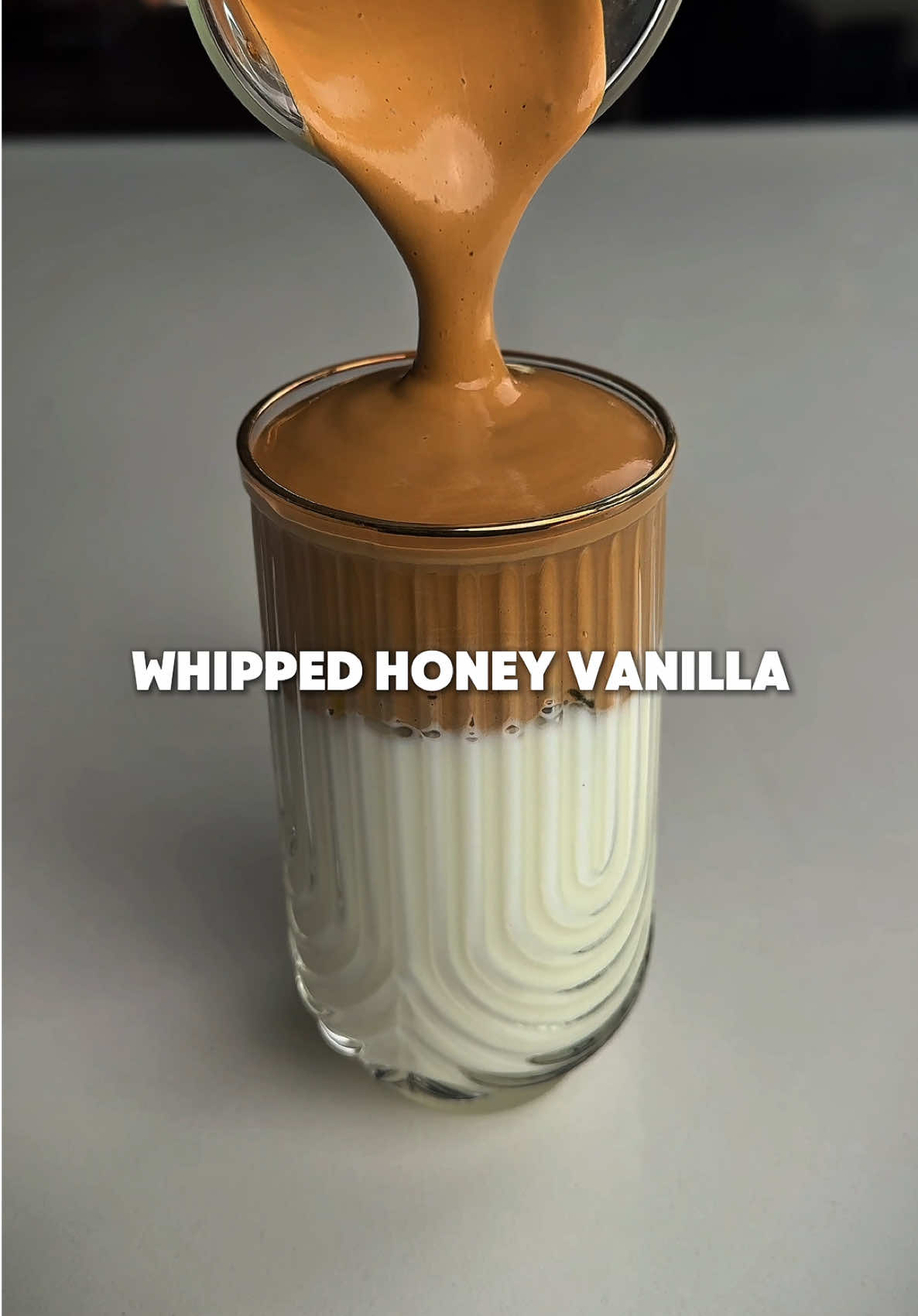 Whipped Honey Vanilla Iced Coffee—one of the best iced coffees you can make at home. It’s creamy, smooth, and full of flavor. Here’s how to make it: • Start with 2–3 tbsp honey • Whip it using a hand blender until light and smooth Then add: • 2 tbsp instant coffee • 1 tbsp sugar • 2 tbsp water  Whip until golden, fluffy, and thick In a glass: • Add ice • Pour in 0.5 oz vanilla syrup • Add milk • Top with your whipped coffee That texture is unreal. Try it and taste the difference. Give this a like if that whipped coffee looks cool to you, and follow for more. #whippedcoffee #dalgonacoffee #icedcoffee #coffeeathome #coffeerecipe #coffeetok #baristatok #homemadecoffee #summercoffee #vanillacoffee #aestheticdrinks #drinktok #viralcoffee #latteideas #coffeecreation