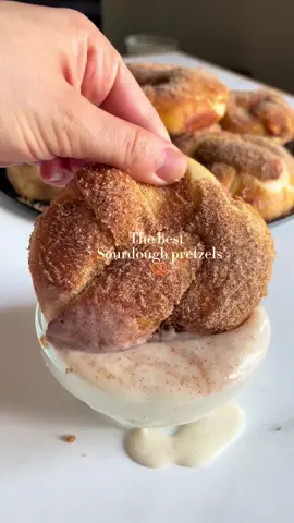 These are the best sourdough pretzels you’ll ever taste 🥨 This is my recipe, and I’m so excited to share it with you so you can bake them too and fall in love like I did. Soft, fluffy, and cinnamon-sweet! Perfect with a vanilla glaze dip. Ingredients: 	•	530 g bread flour (or 80% bread flour + 20% all-purpose) 	•	110 g active sourdough starter (100% hydration) 	•	70 g honey (adds flavor and golden color) 	•	300 ml milk (room temp or slightly warm) 	•	10 g salt 	•	1 tsp cinnamon 	•	1 egg yolk (for softness and color) 	•	70 g melted butter (add after autolyse) 	•	1 tsp vanilla extract Cinnamon Sugar Coating: 	•	5 tbsp butter, melted 	•	1 cup white sugar 	•	1 tbsp cinnamon → Mix sugar and cinnamon in a bowl and set aside. Steps: 1. Autolyse: 	•	Mix flour, milk, honey, and sourdough starter. 	•	Rest 40 minutes to improve dough extensibility. 2. Add the rest: 	•	Mix in yolk, salt, and vanilla. 	•	Knead 5–10 minutes, then slowly add melted butter. 	•	Knead until dough is smooth and elastic. 3. Bulk Fermentation: 	•	Cover and ferment 4–6 hrs at room temp. 	•	Stretch & fold every 30 mins for the first 2 hrs. 	•	Refrigerate for 8–12 hrs (for better flavor + easier shaping). 4. Shape Pretzels: 	•	Divide dough into 100 g pieces. 	•	Roll into ropes and shape into pretzels. 5. Final Proof: 	•	Let pretzels rise at room temp for about 2 hours or until puffy. 6. Baking Soda Bath: 	•	Boil 1 liter of water + 30–40 g baking soda. 	•	Dip pretzels for 15 seconds each. 7. Bake: 	•	Bake at 200–210°C (390–410°F) for 15–18 minutes, or until golden brown. 8. Cinnamon Sugar Topping: 	•	While still warm, brush pretzels with melted butter, then coat with cinnamon sugar. ⸻ Vanilla Glaze (Dip): 	•	1 cup powdered sugar (sifted) 	•	3 tbsp milk 	•	1 tbsp vanilla extract → Mix until smooth. Use as a sweet dip for your pretzels! #CapCut 