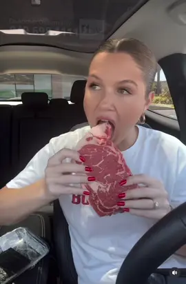 A woman eating a raw steak wow #fyp #steak #raw #viral 