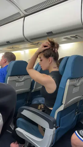 girl on plane signals for help