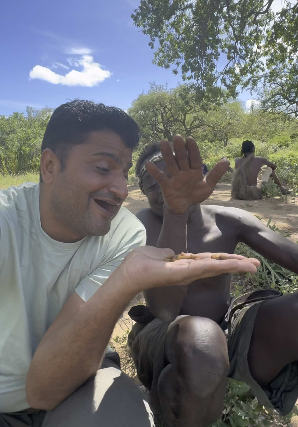 Dudukwe’s almond debut—he munched them all at once! 😄🌰 Fed Dudukwe almonds for the first time and guess what? No hesitation—just grabbed a bunch straight from my hand and crunched away! His reaction was so wholesome and funny 😆 Stay tuned, this bonding moment is one for the books 💛 #friends #friendshipgoals #friend  #Hadzabe #RoamingWithVinu #TribalLife #FirstTimeTasting #AlmondsReaction #CulturalExchange #Tanzania🇹🇿 #TribeTok #RealConnections #ExploreCultures #TikTokOriginals #NatureAndNuts 🌍🌰