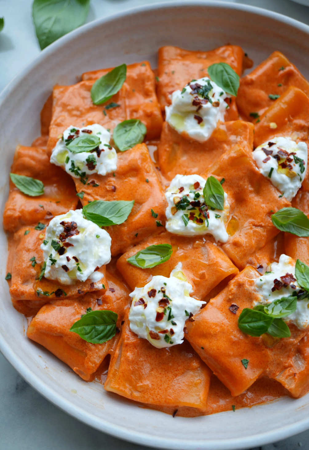 ✨Paccheri Alla Vodka with Burrata & Basil✨ Spicing up this easy vodka sauce recipe with some burrata, chili flakes and fresh basil! 🌶️🍝🌿 Full recipe on my website!  Ingredients: - 1/2 lb. paccheri - 2 tbsp. extra virgin olive oil - 1/2 shallot, finely chopped - 4 garlic cloves, minced - 6 oz. tomato paste - 1/2 tsp. salt - 1/4 cup vodka - 3/4 cup heavy cream - 8 oz. burrata  - Basil for garnish  - Basil oil and chili flakes to finish  - Pasta water as needed  #pasta #Recipe #vodkasauce #ThePastaTable 