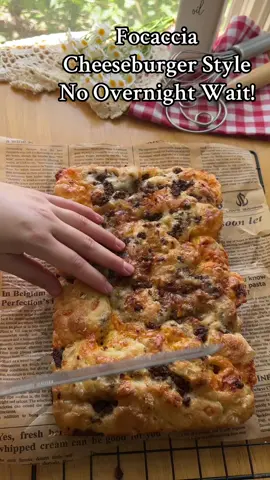 Cheeseburger Focaccia , No Overnight Wait!  Ingredients: 	•	270g all-purpose flour  	•	200ml warm water( not hot) 	•	½ tsp instant yeast 	•	¾ tsp salt 	•	¾ tsp sugar 	•	1½ tbsp olive oil (plus more for greasing and topping) Filling (as needed): Caramelized onion, cooked ground beef, grated cheddar cheese Instructions: 	1.	Mix  salt, sugar and yeast. Add water , oil and flour .Mix into a sticky dough. 	2.	Cover and let rise until doubled (about 1–1.5 hours). 	3.	Grease your mold. Spread the dough in it, add half the filling, fold the dough over, turn it . 	4.	Drizzle a little oil on top, cover, and rest 40 minutes. 	5.	Add rest of filling on top and dimple the dough with oiled fingers. 	6.	Bake at 220°C (428°F) for 20–30 minutes until golden. #focaccia #cheese #focacciabread #baking #dough #homemadebread #homemade #bakingfromscratch #breadtok #bread 