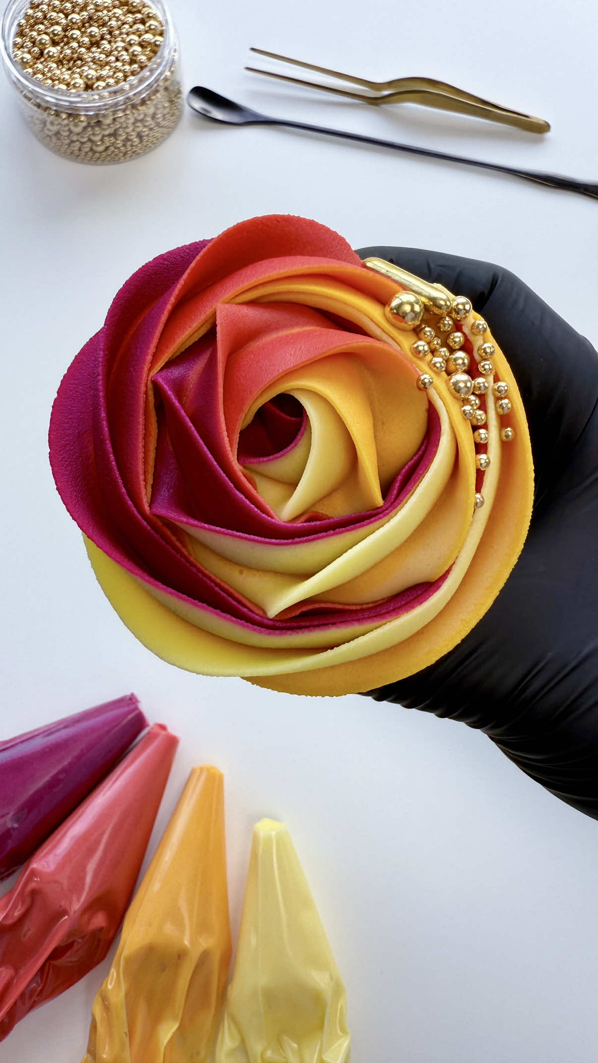 A sunset themed buttercream rosette cupcake with the prettiest gold sprinkles 💕🧡💛 #cupcakedecorating #cupcakeideas #rosette #sunsetlover #sunset 