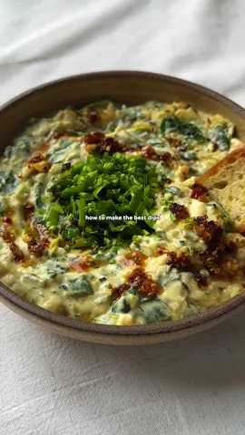 CARAMELISED LEEK, CREAM CHEESE + SPINACH DIP 🤤 welcome back to TAKE A DIP SEASON 3 - the series where I show you how to make the best dips in town.  for EPISODE 7, I’ve made my CARAMELISED LEEK, CREAM CHEESE + SPINACH DIP 😍 it’s creamy, lemony, delicious + indulgent, whilst being ready in no time at all. as always, I’ve written the full recipe for you below - so enjoy! and let me know if you give it a go in the comments below…👇  INGREDIENTS (serves 4-6) 100g spinach 1 medium leek 2 garlic cloves 2 tbsp nutritional yeast (I use instead of parmesan) 15g fresh tarragon 15g fresh chives 400g cream cheese (I use @juliennebruno) 1 tsp dijon mustard 1 tsp miso paste 1 lemon 1 tbsp chilli crisp Salt + pepper METHOD 1. Sauté the leek until softened + caramelising. Add the garlic, frying until fragrant. Then add the tarragon.  2. Blanch the spinach + squeeze out moisture.  3. In a bowl, add the leeks, spinach, then cream cheese. Add the miso, mustard, nutritional yeast +  lemon juice. Season with salt + pepper, mix + taste.  4. To serve, spoon into a bowl. Top with chives + chilli crisp. Serve with toasted baguette + enjoy! #dip #leek #spinach #EasyRecipes 