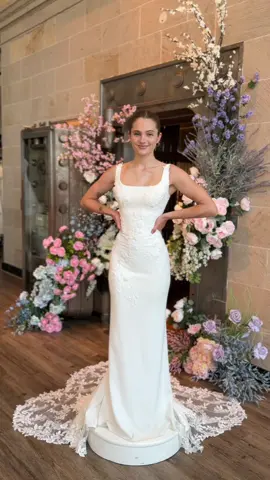 Meet “Amaya”  A gorgeous clean fit and flare crepe gown with the most beautiful floral detailing. 3D lace and appliqué add dimension and fun to this classic gown, finished with a lace cut out train. Which detail do you love most?  #WeddingDress #WeddingDressInspiration #BridalShop #Bride #BrideGoals #wedding #gown 