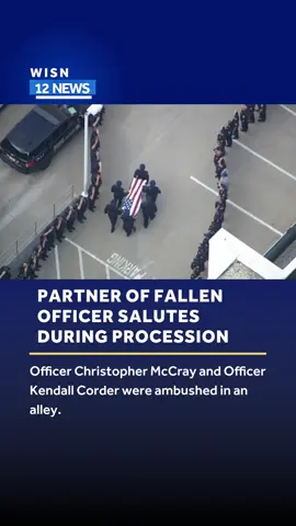Officer Christopher McCray salutes his partner and fallen Officer Kendall Corder as the procession began on Sunday. McCray was released from the hospital the day before.