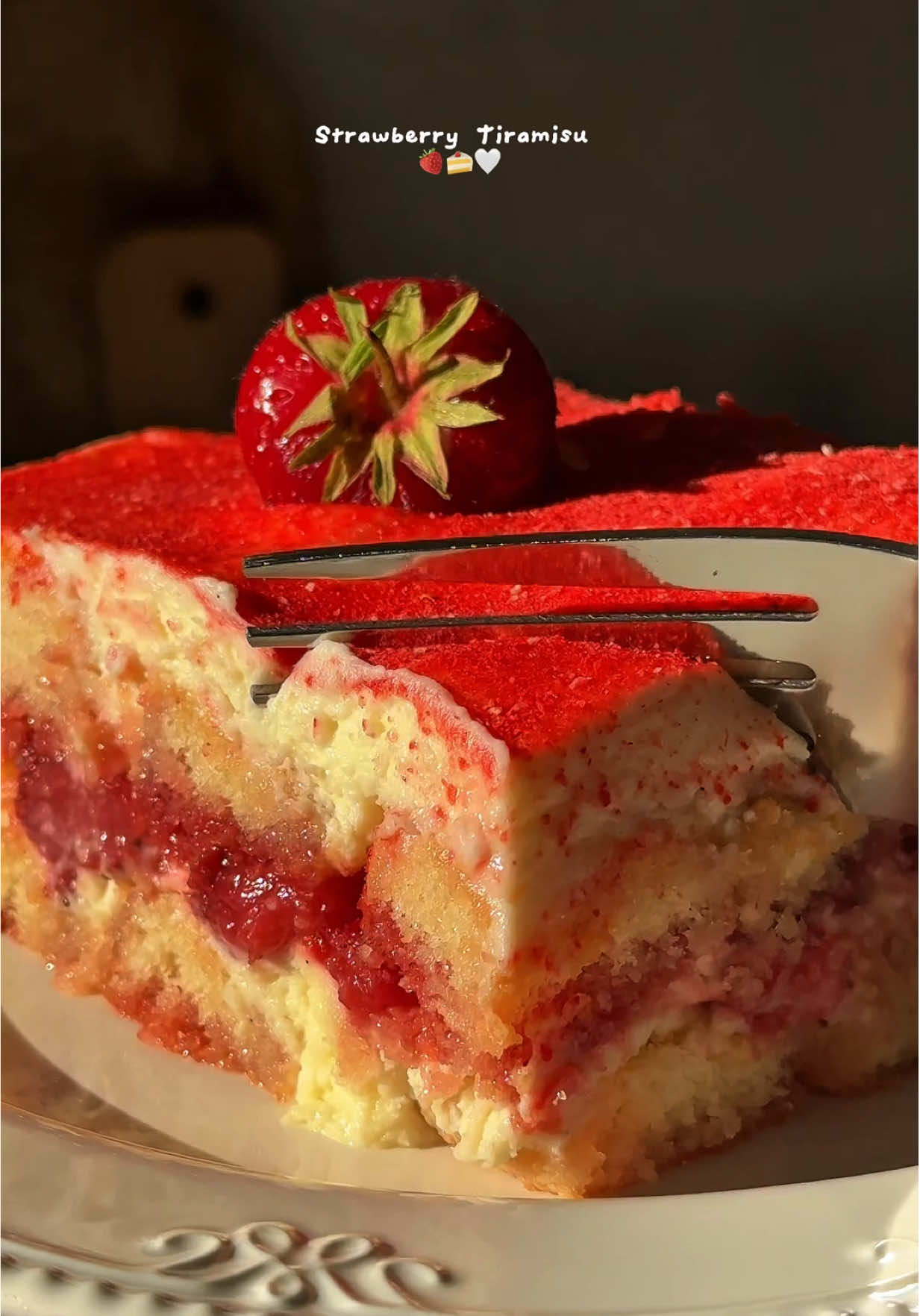 Strawberry Tiramisu 🍓🍰🤍 -  Ingredients: For the strawberry compote & strawberry water: - 300g strawberries, diced up - 130g granulated sugar - 1 teaspoon vanilla bean paste or vanilla extract - 60g water For the mascarpone cream: - 500g mascarpone - 350g whipping cream - 150g granulated sugar - 1 teaspoon vanilla bean paste or vanilla extract Extras: - Ladyfigers, for the layers - Optional, freeze dried strawberries (blended into a powder) Instructions: 1. For this recipe I used a 20x25 cm ceramic pan. 2. First, prepare the jam and the strawberry water. 3. Add the diced strawberries, the sugar, vanilla and the water to a small saucepan. Bring it to a simmer then reduce the heat to medium and let it cook for 5 minutes. After 5 minutes, pour out most of the water (about 200g) into a separate bowl (we will use this to dip the ladyfingers in). Let the rest of the compote cook a little longer until it thickens. Once ready, take it off the heat and let it COMPLETELY cool. (Both the compote and the water) 4. Once cold, time to prepare the rest of the components. 5. To prepare the cream, mix together the mascarpone with the sugar and vanilla until smooth. I recommend doing this gently, using a spatula. 6. In another bowl, beat the whipping cream until stiff peaks form, then gradually scoop it onto the mascarpone mixture and gently fold it in. 7. To assemble the cake, dip the ladyfingers into the strawberry water we prepared earlier and place them into your dish. Then add  about half of mascarpone cream and all of them jam. Top with another layer of ladyfingers and cream. 8. Optionally, top with strawberry powder. 9. Refrigerate for a minimum of 4 hours before serving. Enjoy! #tiramisu #strawberries #strawberrytiramisu #nobake #nobakedessert #summerdessert #baker #foodblog #foodblogger #FoodTok #EasyRecipe #quickrecipes #asmr #asmrfood 