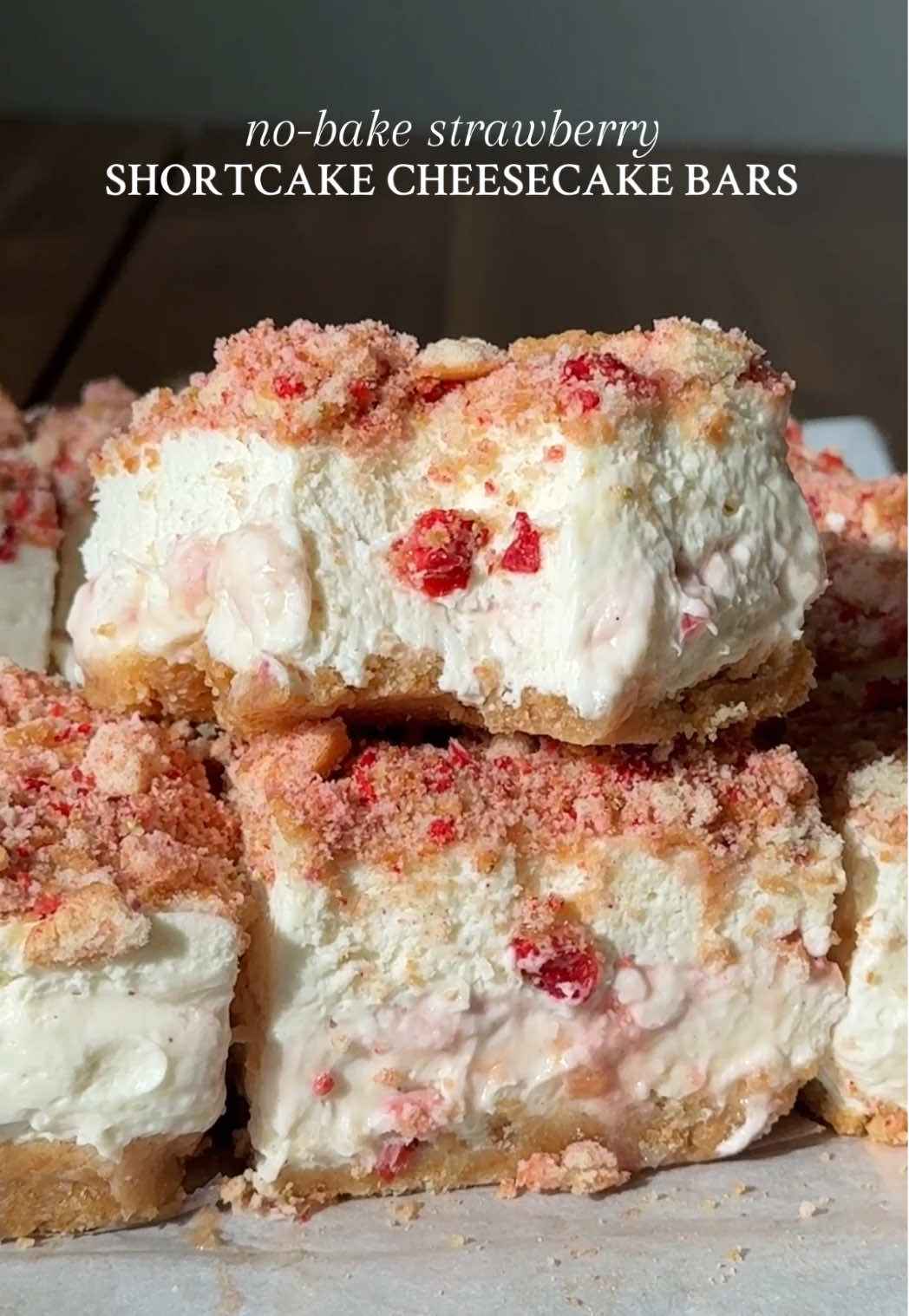 NO-BAKE STRAWBERRY SHORTCAKE CHEESECAKE BARS They’re every bit of bright, creamy, crunchy and nostalgic, and just SO perfect for summer 🍓✨ Recipe below OR go my website through the link in my bio 🤎 #Recipe Details (makes 9-16): Nilla Wafer Crust: - 1 1/2 cups (200g) crushed nilla wafers  - 1/2 cup (113g) salted butter, melted Vanilla Bean Cheesecake Filling: - 1 cup (240ml) heavy cream, cold - 24oz (3 blocks) cream cheese, at room temperature - 1 1/3 cups (160g) powdered sugar - 1/3 cup (85g) Greek yogurt, at room temperature (substitution: sour cream) @FAGE  - 2 tsp (8g) vanilla extract or paste @Amoretti-  - Pinch of salt - Optional: 1/3 cup (113g) strawberry preserves, for swirling @Bonne Maman US  Strawberry Shortcake Crunch Topping: - 3/4 cup (100g) nilla wafers - 1oz freeze-dried strawberries Instructions: Line an 8x8” square pan with parchment paper; set aside.  Prepare the crust. Blitz the nilla wafers in a food processor or bender until finely ground.  In a medium bowl, combine the ground nilla wafers and melted butter. Mix until the mixture resembles wet sand and comes together when pressed together. Press the crust mixture into the bottom of the prepared pan, using a measuring cup, the bottom of a glass, or your fingers to press across the bottom into an even layer. Place into the freezer while you prepare the cheesecake filling. Prepare the cheesecake filling. In a large bowl with an electric handheld mixer or by hand with a whisk, beat the cream cheese to smooth. Then add in the powdered sugar, Greek yogurt, vanilla, and salt. Beat until well combined and smooth.  In another bowl or the bowl of a stand mixer fitted with the whisk attachment, beat the heavy cream until stiff peaks for (~2-3 minutes), being careful not to over-beat. Using a spatula, fold the whipped cream into the cream cheese mixture, until fully combined and smooth.  Spread half of the cheesecake filling over the chilled crust in an even layer.  Then dollop strawberry preserves all over, and use a knife or toothpick to gently swirl. Spread the remaining cheesecake filling in an even layer over the swirled strawberry preserves, smoothing out the top with an offset spatula. For the strawberry shortcake crunch, add the nilla wafers and freeze-dried strawberries to a ziplock bag. Close tightly and crush to form rough chunks. Generously sprinkle the strawberry shortcake crunch topping all over the surface of the cheesecake filling and gently press down. Cover the pan with plastic wrap or foil and refrigerate for at least 8 hours or overnight.  Once ready to serve, lift the parchment paper out of the pan and place onto a flat surface. Slice into 9 or 16 squares. Serve and enjoy! #strawberryshortcake #cheesecake #cheesecakebars #nobakecheesecake   #cheesecakerecipe #summerdessert #summerrecipe #strawberrycheesecake #nobakerecipe #nobakedessert #dessert 