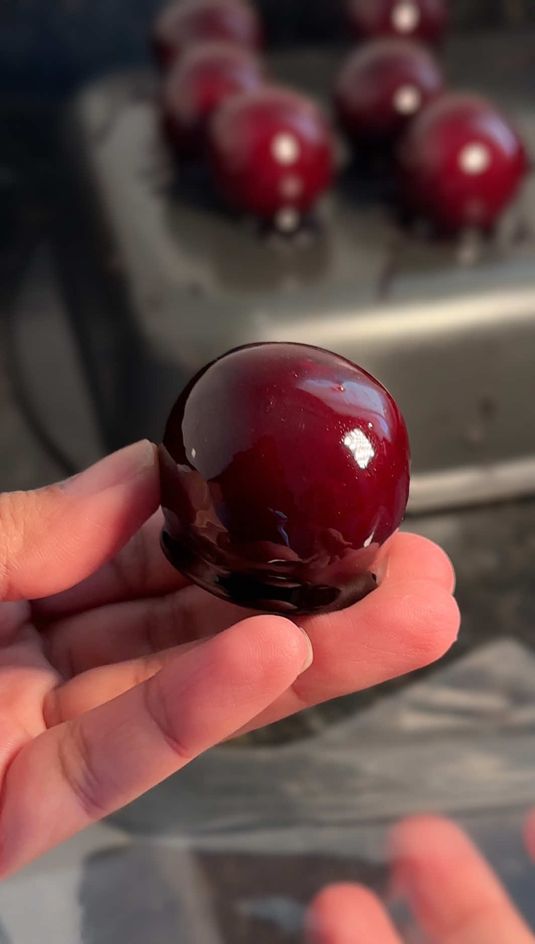 Aprenda de uma vez por todas a fazer a calda de açúcar que forma a casquinha PERFEITA para banhar os seus doces. Fininha e que não gruda na embalagem 😍🍓🍎 Receita da calda: 520g de açúcar cristal  75g de vinagre de álcool  75g de água 2 colheres de sopa de corante em gel Para a casquinha ficar perfeita e não grudar na embalagem, 3 pontos são essenciais: 1 - ponto do doce O ponto do doce deve estar bem firme, pode até deixar passar um pouquinho o ponto de enrolar, Só cuidado para não queimar. Não resfrie. Mantenha em temperatura ambiente.  2 - Ponto da calda O ponto da calda deve estar perfeito. Faça o teste na água em temperatura ambiente conforme mostro no vídeo. 3 - embalagem  As embalagens mais finas e comuns vão grudar no doce mesmo que o ponto da calda esteja perfeito. Use uma embalagem de polipropileno. Dica extra para facilitar o banho e não queimar a calda: assim que atingir o ponto perfeito, transfira a calda para uma panela fria e de tamanho menor. A panela fria vai parar o aquecimento da calda e o tamanho menor vai te dar mais profundidade para banhar os doces com mais facilidade.  Dica para o doce não grudar depois de banhar na calda: use o fundo de uma forma untada com desmoldante ou óleo.  Já salva o vídeo e me segue pra não perder as próximas receitas 🫶🏾 #morangodoamor #macadoamor #balabaiana #caramelo #doce #receitas #recipes #tiktokreceita #tiktokrecipe 