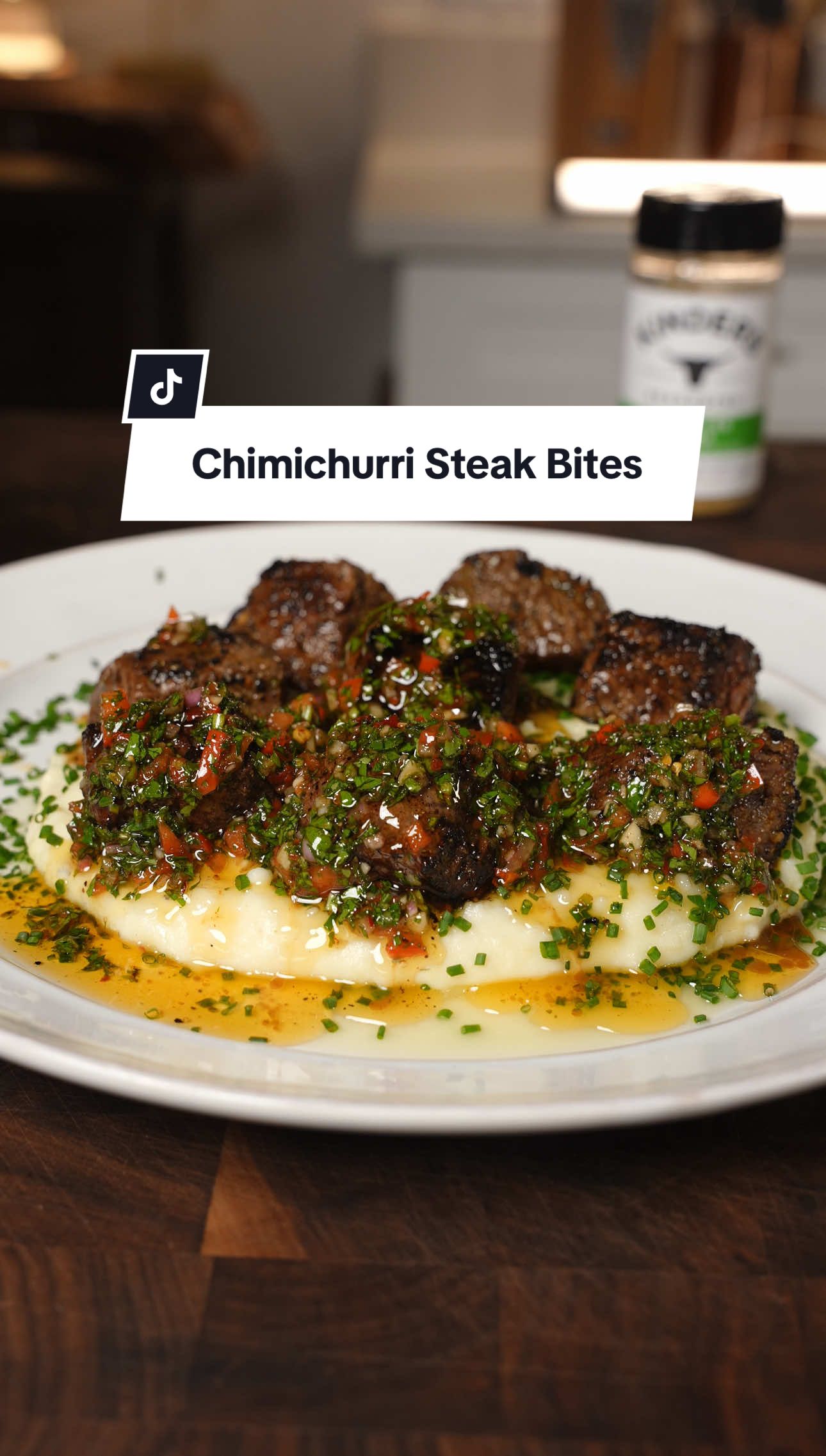 Chimichurri Steak Bites Recipe ⤵️⤵️⤵️ Before I jump into the recipe you can find @Kinder's Flavors Brazilian Steak Seasoning at @Walmart and it absolutely elevated this dish! 😮‍💨 Steak Ingredients:  2 Ribeyes  4 Tbsp Kinder’s Brazilian Steak Seasoning 2 Tbsp Avocado Oil How to: Cut Ribeyes into 1x1 inch cubes, season, and sear a minute on all sides  Chimichurri Ingredients: 1 Bunch Parsley 1 Bunch Cilantro 4 Garlic Cloves 1 Shallot 1/2 Red BellPepper 1 Tbsp Kinder’s Brazilian Steak Seasoning 1 Tsp Red Pepper Flakes 1 Tbsp Paprika  1 Cup Avocado Oil 4 Tbsp Red Wine Vinegar  1 lemon How to: Mince all the fresh ingredients fine and add to a bowl with the rest of the ingredients, mix, and it’s good for about a week in the fridge.  Garlic Mashed Potato Ingredients:  8-10 Yukon Gold Potatoes  4 Tbsp Brazilian Steak Seasoning 8 Tbsp Butter  1 Cup Cream or Sour Cream 2 Garlic Bulbs How to: Cut Yukon Potatoes into small pieces and boil in salted water for about 15-20 minutes or until fork tender. Mash the potatoes and add the Brazilian Steak Seasoning, melted butter, and cream. I also added 2 roasted garlic bulbs that I wrapped in foil and put in the oven for 30 minutes at 375 degrees. Give that all a good mix and enjoy!  #chimichurri #steak #bites #dinner #idea #TasteOfKinders #KindersPartner 