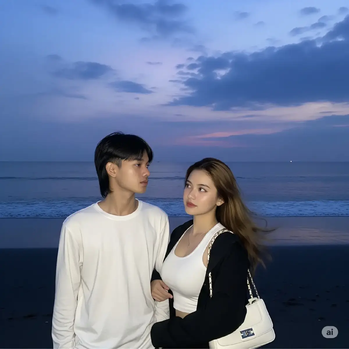 Dua orang muda mudi, seorang pria dan seorang wanita asal indonesia, berdiri di tepi pantai menghadap ke kamera saat senja. Pria itu memakai baju lengan panjang putih, wajah menghadap kamera namun kepalanya sedikit menoleh ke kanan, melihat ke arah wanita di sampingnya. Tangan kanannya memegang lengan wanita. Wanita itu mengenakan crop top putih dengan jaket terbuka, dengan rambut bergelombang sebahu, dan membawa tas tangan putih dengan tali rantai yang melingkar di bahunya. Mereka berdiri di atas pasir gelap yang basah oleh ombak yang datang. Laut berwarna biru tua dengan riak-riak kecil yang memantulkan sisa cahaya senja yang realistis. Langit di atas mereka didominasi warna biru gelap dengan sedikit gradasi ungu dan awan tebal yang menyebar. Di kejauhan, di garis cakrawala laut, terlihat sebuah titik cahaya yang samar. Suasana keseluruhan foto terasa tenang dan romantis. Foto diambil dari depan pasangan tersebut, memfokuskan pandangan mereka ke arah laut yang luas. rasio 3:4 #ai #aiart #aigemini #chatgpt #fyp 