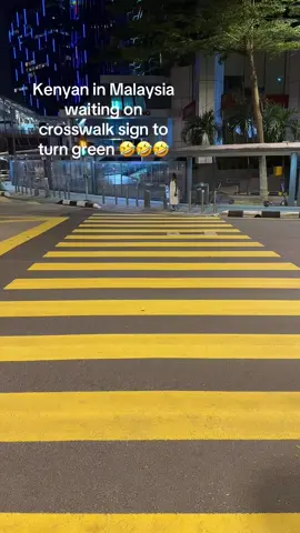 A Kenyan in Malaysia, patiently waiting for the crosswalk light to turn green… Like it’s an exam and failing means deportation 😭😭😭 In Nairobi: “We look left, we manifest right, then we run.” In Kuala Lumpur: You stand there… like you’re waiting for the ancestors to say, “My child, proceed.”