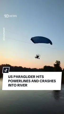 A US paraglider has crashed into a river in North Dakota after striking powerlines mid-flight. Vision shows the paraglider gliding through the air before making contact with powerlines, causing a loud spark before falling into the Red River. Emergency services were called to the scene and rescued the paraglider from the river. #powerglider #US #redriver 