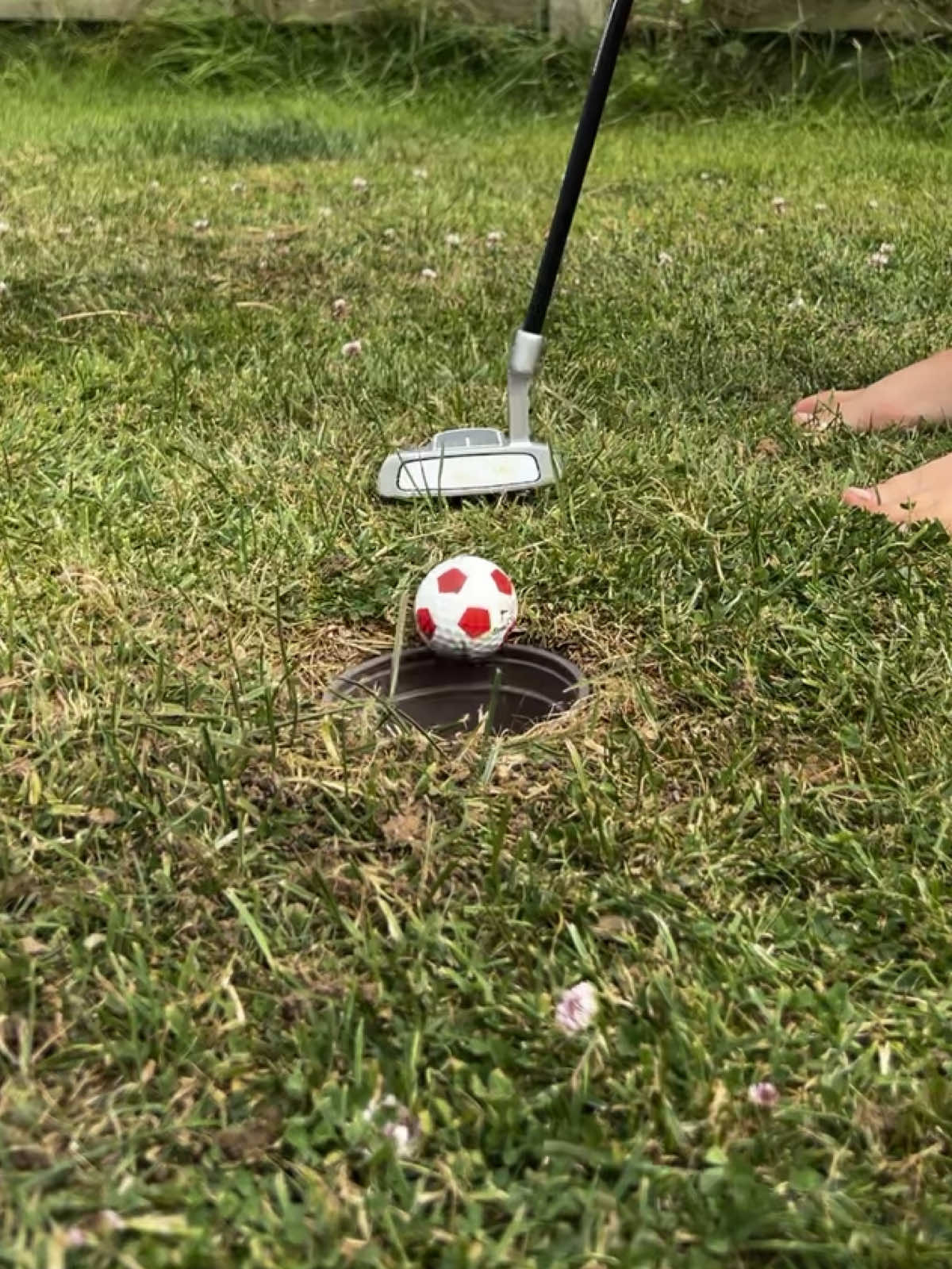 Wow 🤩 the hours of fun you can have from making your own putting hole ⛳️  My Dad did this for us as kids so I had to do it for my little golfer 🏌️  We dug a small hole and used a small plant pot as it has drainage but also has solid sides 🤩  #DIY #golf #golftiktok #puttinggreen #garden #kidstiktok #summerholidays #kidsactivities #mumsoftiktok #mumofboys #activekids 