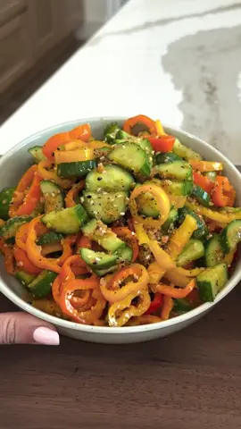 VIRAL PEPPER AND CUCUMBER SALAD lives rent-free in my summer snack rotation 🥒🌶 It’s crunchy, a little spicy, a little tangy, and somehow tastes even better the longer it sits. All you need are cucumbers, mini peppers, your favorite ginger dressing, chili crunch, and a big sprinkle of everything but the bagel seasoning. comment RECIPE for the full details on my blog, or visit lovelydelites.com  it’s such a low effort, high flavor snack that you are going to LOVE. SAVE and TAG when you try it!  IB: @rachael  3 Persian cucumbers (can sub regular) 10 tri colored sweet bell peppers 2 Tbsp everything but the bagel seasoning 1/3 cup ginger dressing 2 Tbsp chili oil crunch Start by slicing the sweet bell peppers and dicing the cucumbers into bite sized pieces. Add the veggies to a bowl and top with the ginger dressing, chili oil crunch and EBTB seasoning. Mix well until each veggie is well coated. Serve as it, or enjoy with your favorite meal. #peppercucumbersalad #viralrecipe #summersnacks #healthyrecipes #healthysnacking 