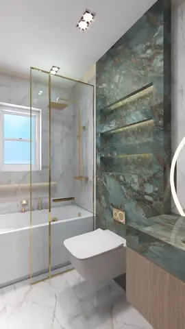 This bathroom design is stunning—luxurious, bold, and modern. Here's a breakdown of what makes it work, and how you can replicate or draw inspiration from it Color Palette: Deep green marble with rich veining in brown and white White and light gray marble walls for contrast and lightness Gold fixtures (shower, taps, flush plate) that elevate the space with a touch of glam 🛠 Materials: Polished marble (green for the feature wall and vanity, white for the rest) Glass partition with gold trim—adds lightness while defining space Wall-mounted toilet for a clean, floating look Integrated LED lighting in shelf niches—adds depth and drama 💡 Lighting: Warm, soft lighting that enhances the stone textures Modern backlit mirror (likely LED) for both aesthetics and function 💡 Design Ideas You Can Steal Feature Wall with Backlit Niches Create a statement wall behind the toilet or vanity with a richly veined stone slab and recessed shelves lit from within. Gold Framed Shower Glass Gold adds warmth and luxury—opt for brushed gold for a more muted, modern look. Floating Vanity & Toilet Keep the floor visible to make small bathrooms feel more open. Two-Tone Stone Strategy Use a bold stone (like the green one) for an accent, and balance it with subtle whites or light grays elsewhere. Minimal Fixtures, Maximum Impact Keep faucet and handle designs simple, but in a luxe finish like brass or gold. 🛍 Material Suggestions (or Similar Looks) Green Marble Look Tile: Try “Emerald Onyx” porcelain tiles for a similar effect if real marble is too costly. White Marble Tiles: Calacatta or Statuario porcelain for low-maintenance luxury. Fixtures: Brushed gold hardware (Kohler, Brizo, or Grohe have good collections). Lighting: Integrated shelf LED strips (Philips Hue or custom under-cabinet strips). #LuxuryBathroom #ModernBathroom #BathroomGoals #SpaBathroom #ElegantInteriors #BathroomInspo #bathroomdesignideas 