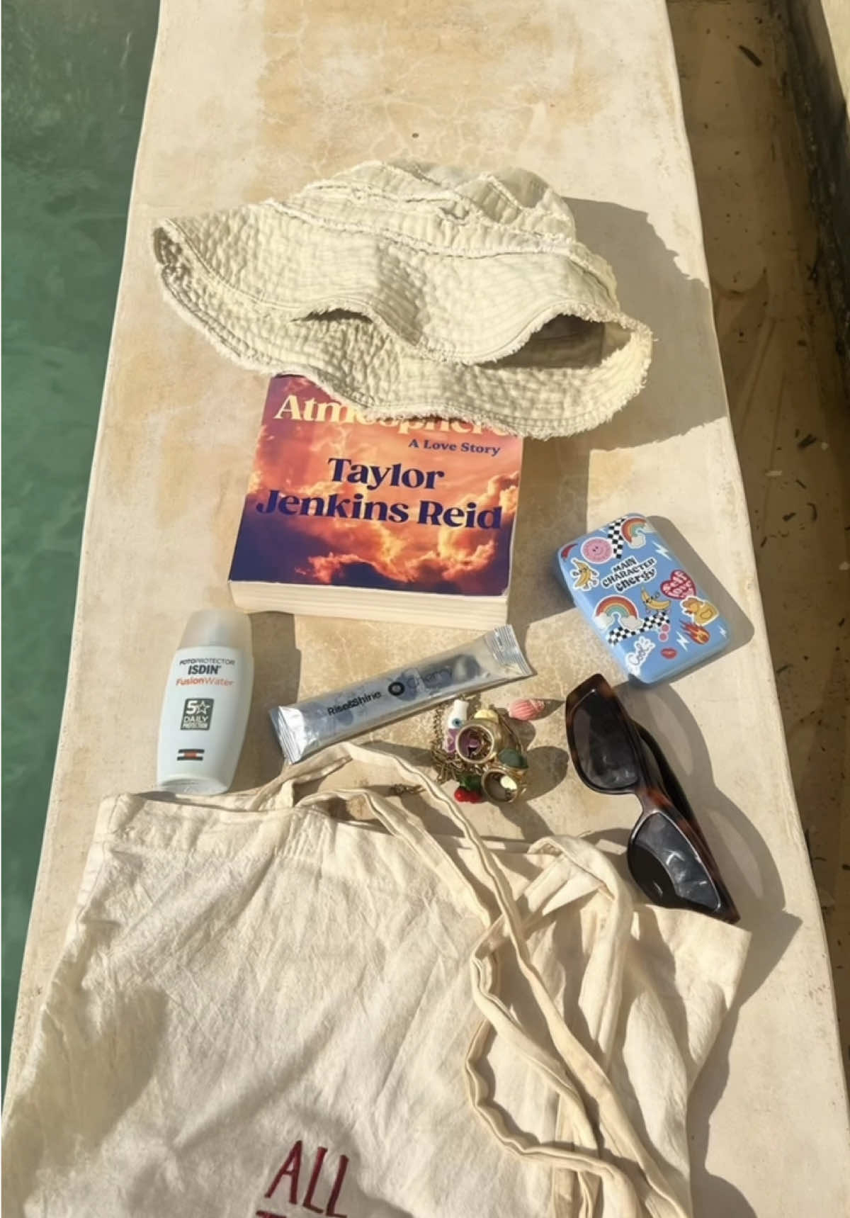 My must-haves for a dreamy beach day in Zanzibar 🐚☀️✨ Packing light but smart with skincare, sun protection, and good vibes only 💛 -ISDIN fusion water 50fp  -@cherryselfcare.com stick 4 glowy skin -Good book (astmosphere🍒) m Which one is your non-negotiable for a beach  day?👇  #ZanzibarVibes #ZanzibarDiaries #BeachEssentials #TropicalVibes #MyBeachBag #ugctravel #BeachDayMustHaves #ZanzibarTravel #IslandGirlVibes #BeachLife #ContentCreator #UGCcreator #TravelReels #AestheticVibes #BeachGlow #OceanLover #SunnyDays #WanderlustVibes #BeachLook #SunkissedSkin #ZanzibarDreaming #TravelContent #CreatorLifestyle #BeachOOTD #SandyToes #UGCcommunity #TropicalEscape Zanzibar, beach day must-haves, tropical essentials, beach outfit ideas, sunny day skincare, travel content, island vibes, African beaches, UGC creator, content creator lifestyle, natural beach beauty, beach hacks, summer travel tips, beach packing list, ocean glow, beach skincare essentials, travel-ready musts, exotic destinations, vacation mode on