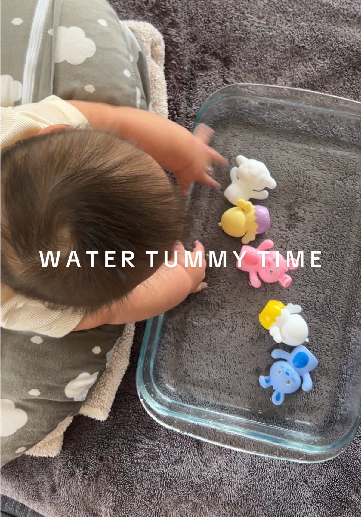 This activity really helped us when we were trying to get our son to do tummy time. It keeps him entertained and makes tummy time last longer without him realizing! All you need is a towel, a nursing pillow or any pillow that’s sturdy and will help elevate your baby, a casserole dish or a tray, water and some colorful toys to float around.  Honestly works like a charm and the moving water and objects provide sensory stimulation and encourage them to lift their head and use their arm and back muscles. This activity also helps with physical development, visual tracking, and hand-eye coordination 🩵 #boymom #tummytime #tummytimetips #tummytimeactivities #momlife #babyboy #babytok #newmomtips #babyactivities 