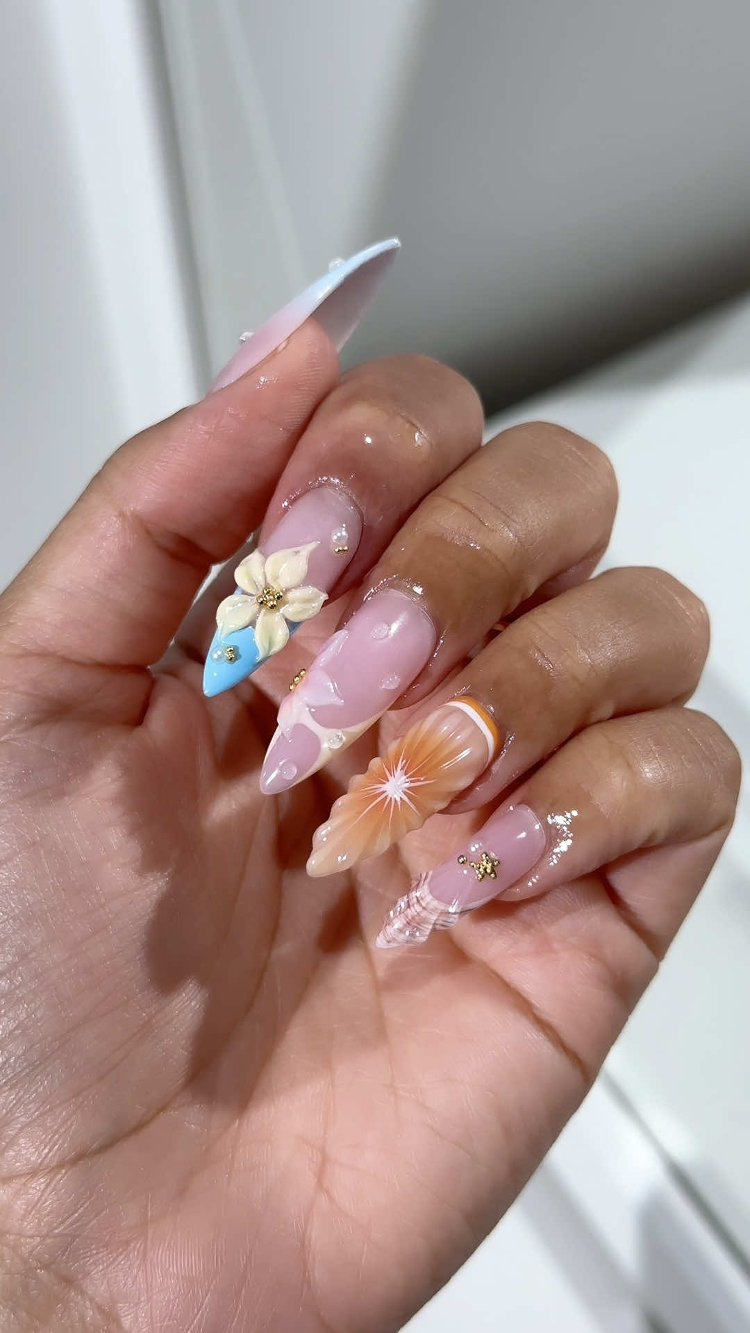 juicy summer nail inspo 🧡🏝️☀️🐚did a 3d orange nails, some flower nails and a shell nail with some gold chrome accents. would you wear these on your next vacation? #3dnails #summernails #juicynails #orangenails #3dflowernails 