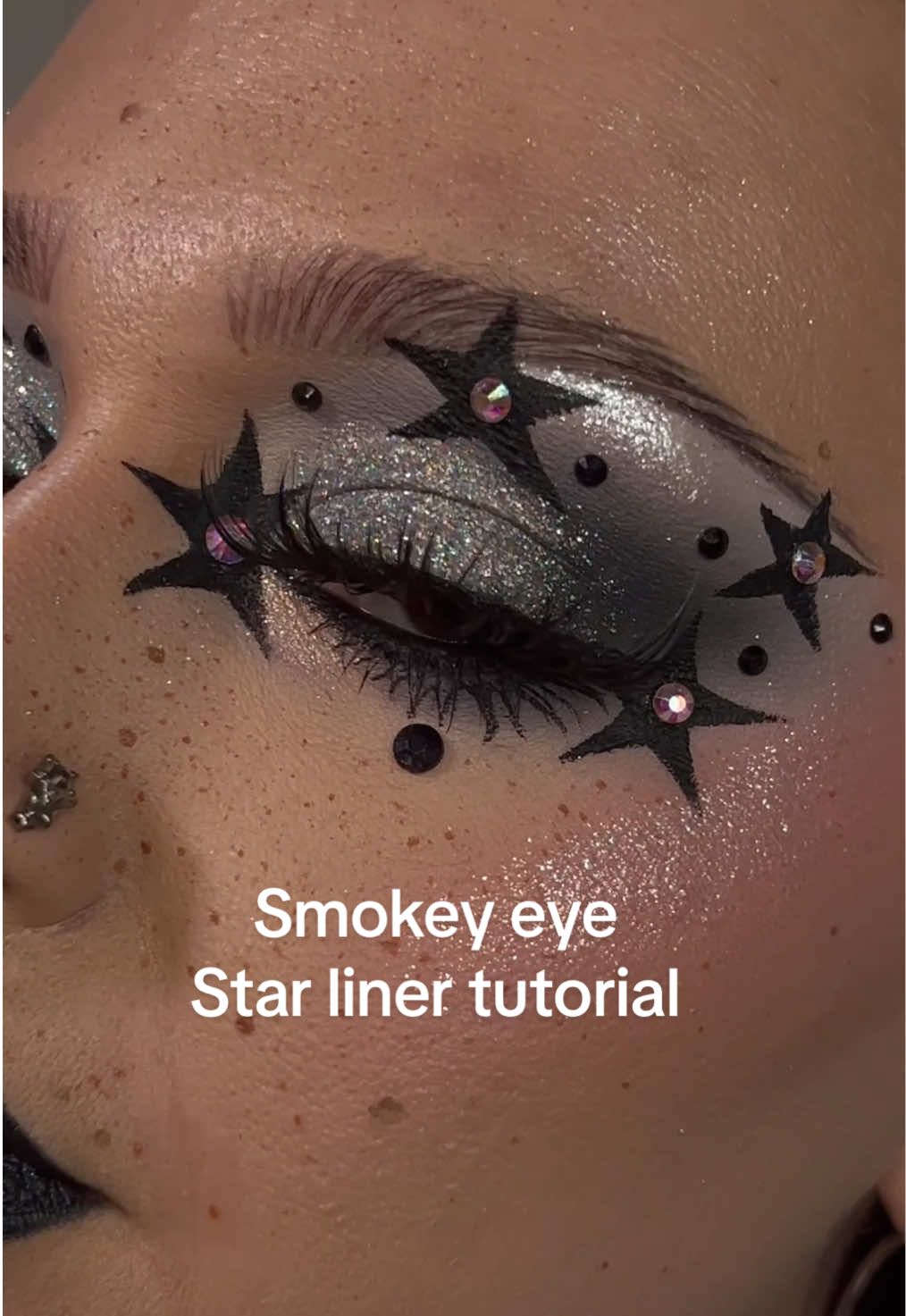 This look... I don't know if I like it or not. My eye kept watering and my liner kept running. I spent over 8 hours on it cuz my watery eye 🙃   I originally didn’t film the star liner tutorial so I redid it today to get this up for those of you who wanted the tutorial 🫶🏻   I'm in a rut & I've been doing more moody looks this week but don't worry, I’ll spread them out & have fun colorful looks too!     Right now the MAM lost signal palette is my obsession. I love the greys in it so much! I wanted sparkles so l paired that palette with my FAVORITE kaima cosmetics glitter! The holographic sparkly loose glitter, yeah, it makes me gasp & makes me smile cuz how pretty it is!! 💜     I hope you had a good weekend 💜      @Gerard Cosmetics clean canvas in fair     @Makeup A Murder, INC. lost signal palette     @Kaima cosmetics holographic loose glitter     @dieverunecosmetics dewdrops part 2 palette & gems      @Terra Moons Cosmetics light echo      @Glisten Cosmetics LTD x @linsmakeuplooks liner palette     @ColourPop Cosmetics bull chic lip liner, Avila beach bronzer, hot 2 touch blush, pretty fresh foundation and concealer     @NYX Professional Makeup lift & snatch tint   @Anastasia Beverly Hills contour kit     @L.A. Girl Cosmetics blackout liner & glitter magic shimmer shifting lip color in starry night     @SHEGLAM lashes     @UNICOS Cosmetics lower eyelash stamp     Dominque cosmetics translucent setting powder     @Huda Beauty easy blur setting powder #liner #altmakeup #makeuptutorial #starmakeup #smokeyeye 