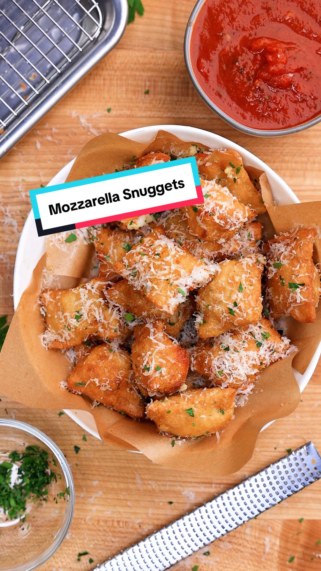Mozzarella Snuggets.
 
 These are mozzarella-stuffed snacks inspired by Naples-style pizza fritta. They're made with pizza dough, sealed like ravioli, fried (or baked), then tossed in garlic butter and Parm and served with a side of marinara.
 
 INGREDIENTS  (makes about 25 pieces)  
 + 1 dough ball (about 270g)  
 + 8 oz low-moisture mozzarella, cubed  
 + Grated Parmigiano Reggiano  
 + Flaked sea salt
 + Marinara (for serving)  
 + Neutral oil (for frying)
 
 GARLIC BUTTER  
 + 3 TBSP unsalted butter, melted  
 + 2 cloves garlic, minced  
 + Fresh parsley, finely chopped
 
 DIRECTIONS  
 + STEP 1: ROLL  
 Cut dough in half. Lightly dust with flour, then roll each piece into a rectangle about 3 inches by 1/8 inch thick.
 
 + STEP 2: ASSEMBLE  
 On each piece, space mozzarella cubes about 1 inch apart over one side of the dough. Fold the dough over the cheese to cover, then press firmly to seal around each cube and at the edges. Cut into individual squares.
 
 + STEP 3: FRY  
 Fry at 350°F for 3–4 minutes per batch, until crisp and golden. (Alternatively, brush with neutral oil and bake at 475°F for 10–12 minutes until golden and crisp.)
 
 + STEP 4: DRAIN  
 Transfer fried nuggets to a wire rack, season with flaked sea salt, and let them drain briefly.
 
 + STEP 5: FINISH  
 Toss in a mixing bowl with garlic butter and grated Parmigiano.
 
 + STEP 6: SERVE  
 Serve hot with a side of marinara.
